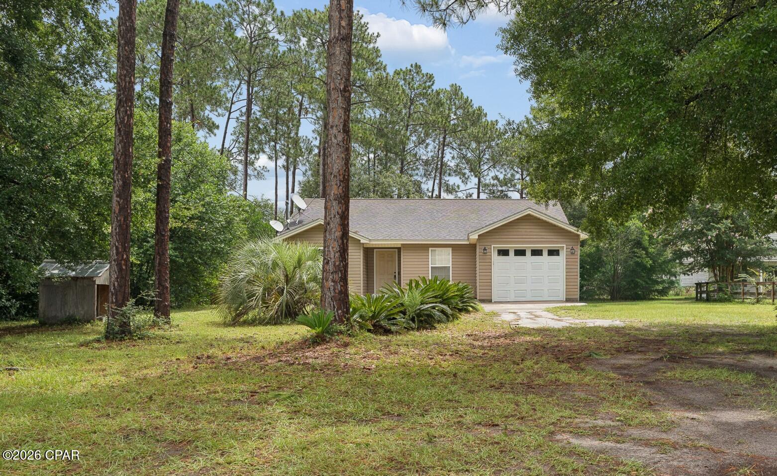 Situated on a generous 0.80-acre lot, this beautiful home offers the perfect blend of peaceful country living with the convenience of being just minutes from shopping, dining, schools, and everyday amenities. Located in one of Bay County's growing areas, this property provides both space and an ideal location.
An extra-wide foyer welcomes you into the home and opens to a spacious family room filled with natural light. Vaulted ceilings and custom built-in features create a warm and inviting atmosphere. The open-concept design seamlessly connects the family room, dining area, and kitchen, making it perfect for everyday living and entertaining.
The two guest bedrooms are generously sized and feature ample closet space. Privately situated at the rear of the home, the spacious primary suite offers a peaceful retreat with a walk-in closet and an en-suite bathroom featuring a convenient roll-in shower.
Outside, you'll find a detached workshop providing abundant storage space and endless possibilities for hobbies, projects, or additional workspace. With its large lot, functional floor plan, and desirable location, this home is one you won't want to miss. Schedule your private showing today!