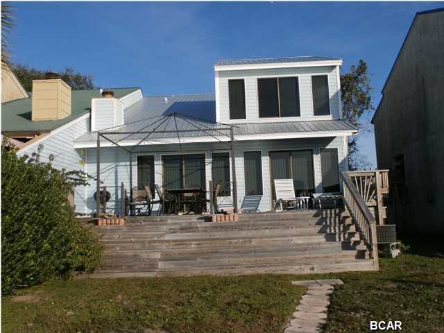 You will love setting on the deck watching the sun sink into the Bay or fishing from the dock. This is a 3 bedroom 2 1/2 Bath Townhouse. Spacious with wood burning fireplace, vaulted ceilings and built-in entertainment center. Washer and drier are as is. The Master Bedroom overlooks the Bay. This is a must see. The 2 car garage has auto opener.