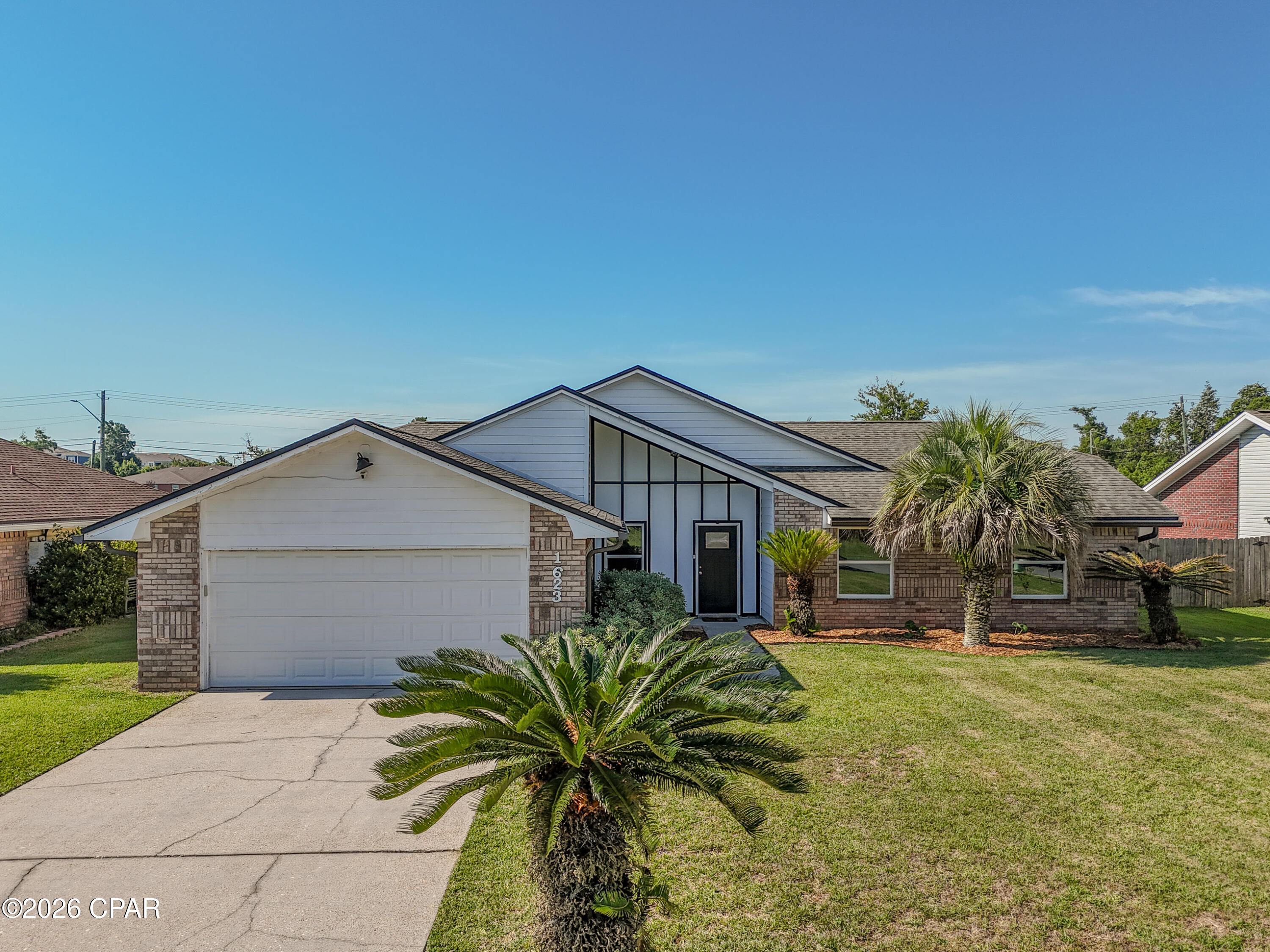 Welcome to1623 Santa Anita Drive, Lynn Haven, FL. This 4 bedroom/2 Bath pool home offers the perfect combination of modern updates, functional living space, and resort-style outdoor living in one of Lynn Haven's most desirable established neighborhoods. This beautifully maintained Florida contemporary home features striking architectural lines, vaulted ceilings, abundant natural light, and exceptional curb appeal with mature palm landscaping and a spacious front yard.

Inside, the thoughtfully designed floor plan offers comfortable living spaces ideal for both everyday living and entertaining. The spacious kitchen serves as the heart of the home and includes a center kitchen island that conveys with the property, providing additional prep space, storage, and gathering space for family and guests. A dedicated coffee bar also conveys, creating the perfect setup for morning routines or entertaining. The laundry room includes an additional storage cabinet that will remain with the home, adding convenience and organization.

The open-concept living areas flow seamlessly while large windows and vaulted ceilings create a bright, airy atmosphere throughout the home. The layout offers the perfect blend of comfort, style, and functionality for families, entertaining, or relaxing at home.

Step outside into your own private backyard oasis featuring a beautiful in-ground pool, expansive fenced backyard, and plenty of room for entertaining, pets, play, or simply enjoying the Florida sunshine. Whether hosting weekend gatherings or unwinding after a long day, this outdoor space delivers the ideal Florida lifestyle.

Located in the heart of Lynn Haven, this move-in-ready pool home offers convenient access to top-rated schools, parks, shopping, dining, boat ramps, and nearby Panama City and Panama City Beach attractions. If you've been searching for a Lynn Haven FL home with a pool, large fenced backyard, vaulted ceilings, and updated contemporary style, 1623 Santa Anita Drive is a must-see.
