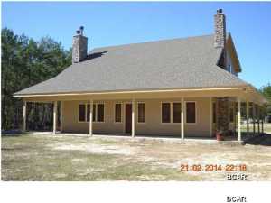 This is a beautiful custom country style home. Home features 360 degree wrap around covered porch with an exterior fireplace, 50 yr fiberglass shingles, spray in insulation in roof. The exterior siding is hardy board. Home is situated on large 3 acre parcel. There is a separate power pole with 220V for RV hook up or for another residence. Located on the property is a large pole barn 2 storage shed and children's playhouse with AC/heat. The interior has some very special features: 2 fireplaces with one being in the master with stacked stone finish, very large master, tiled master bath with walkin closet and separate shower, corner jetted tub. The master is downstairs and two additional bedroom are upstairs. also upstairs are the additional bedrooms, office, and rec room. This is a must