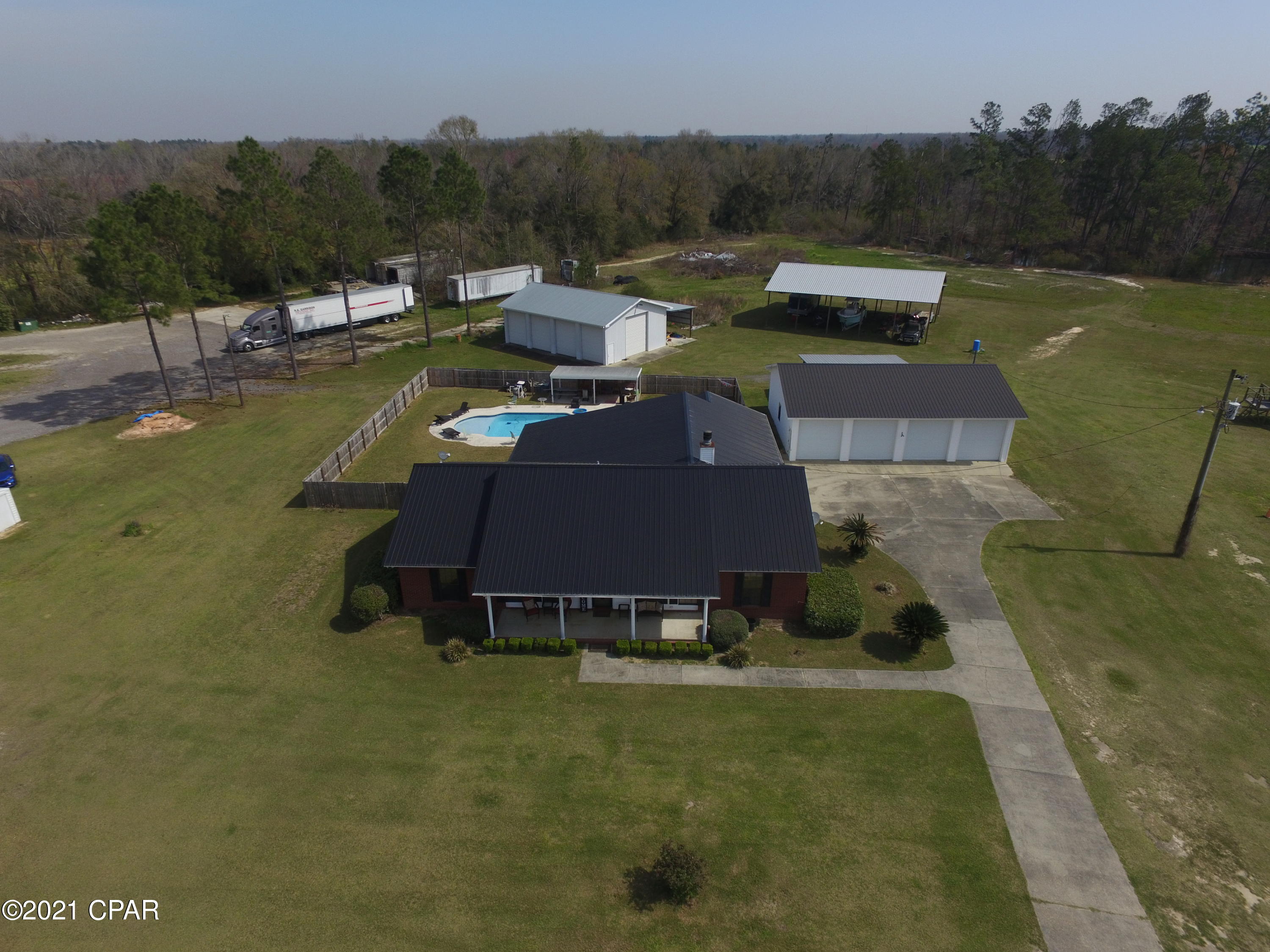 CURRENTLY UNDER CONTRACT, SELLER WILL CONSIDER BACKUP OFFERS.  4/2 with an office on 6.45 acres in Cottondale with way too many bonuses to list! This home has two beautiful living areas, kitchen with dining area, formal dining room, and a 19x22 laundry room!! Curl up beside the fireplace in the winter time and walk out your back door to the pool in the summer! In addition to the amazing 3100sqft home, you'll have a four car garage with roll up doors, a 48x25 shop with FIVE roll up doors, AND a 60x60 pole barn. 3820 Peanut Road shall also be included in the purchase. It comes with a 1488 DW, shop and 3.51 acres, for a TOTAL of 9.96 acres.  Check out the photos.  Make your appointment today.