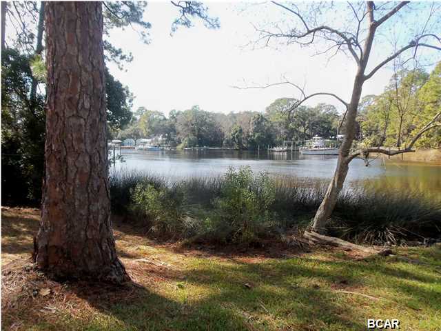 WATERFRONT!! Almost 1 acre on Pratt Bayou..! Well maintained home with 3BRs and 2 Baths. Hardwood floors...Brick fireplace...Nice big windows throughout home...Both baths are tiled; including floors, vanity tops, tub & shower surrounds and 1/2 up the walls.(A little dated but in excellant condition!)...Living and formal dining create an L shape giving the home a very open feel as you walk in...All rooms are spacious...Bedrooms all have generous closet space...9 x 32 raised concrete patio overlooking the water... Laundry room off/in garage... Corner lot...New Roof in 2014...Home is in move in condition, but could use some fresh paint & few updates... GREAT PRICE FOR WATERFRONT!! SELLER MOTIVATED!!...BRING ALL OFFERS!!