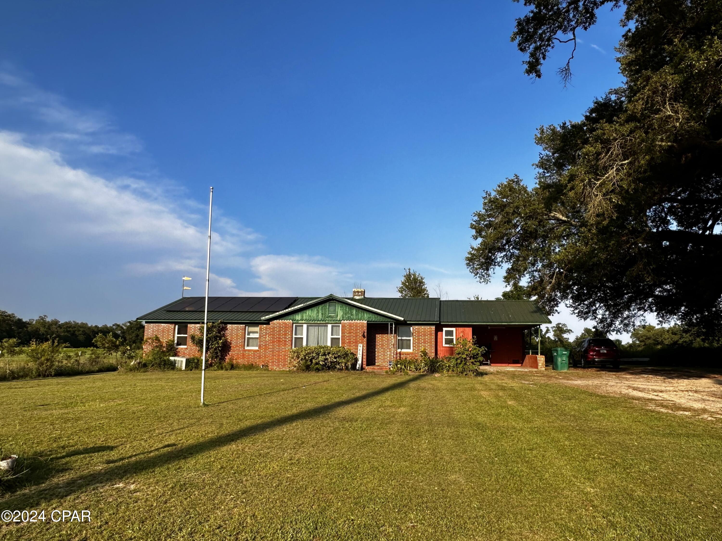 Escape to the tranquility of country living in this charming three bedroom, two bathroom home situated on one acre of scenic land. This property offers the perfect blend of privacy and security, with chain link fencing and a gated entrance. The storage building provides ample space for all your outdoor equipment and tools. Step inside to discover a home adorned with tile flooring and a spacious living area, ideal for entertaining guests or relaxing with family. The recently updated kitchen boasts a modern tile backsplash and brand-new appliances, making meal preparation a breeze. Additionally, this eco-friendly home features solar panels, offering sustainability and energy efficiency. Don't miss out on this unique opportunity, with a little extra TLC this home could finish out to be your own piece of country paradise!
