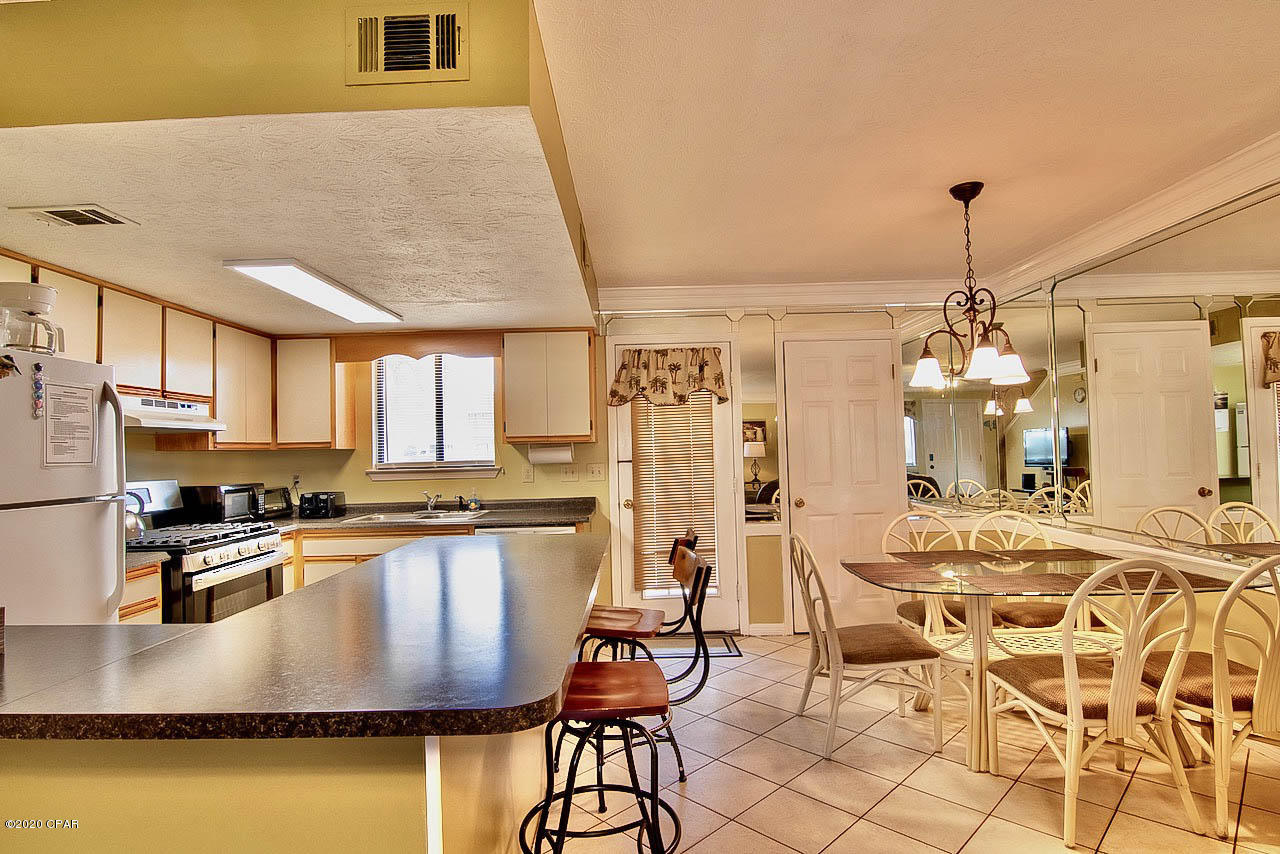 CURRENTLY UNDER CONTRACT, SELLER ACCEPTING BACKUP OFFERS. Very clean and well kept town house, located in an excellent location that has a pool directly in back yard and backs up to the 2 acre miniature golf course.   The complex is a gated community and has 11 swimming pools,  one located across the street behind the restaurant on the gulf.  4 tennis courts.  2 lighted at night.  shuffle board courts and also has 3.2 miles of street area inside the complex, that is great for walking, jogging or just driving around in your golf cart.  HOA allows Owner pets, and there is a playground for the children.