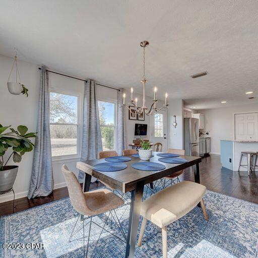CURRENTLY UNDER CONTRACT, SELLER WILL CONSIDER BACKUP OFFERS This turn key home is everything you could want, close to the city but tucked away for privacy, sitting on half of an acre. Located around the corner from Harder's Recreational Park, this 3/2 has new windows, doors, roof, siding and fresh paint (2019/2020). The second bathroom was renovated within the past year and a half. The open floor plan allows for ample space to host/entertain and fellowship with friends and family. Enjoy relaxing evenings under the Florida stars on the back porch and even stay cozy by the fire pit. Say goodbye to a water bill because this home is on a well and had a new submersion pump installed in 2021.  The home has a Wise smart hub in order to be more energy efficient, as well as a smart system for the irrigation. The laundry room has ample storage as well as a convenient utility sink. This is the perfect starter or forever home so call and schedule your showing today. Home is located in flood zone X. Buyer to verify all measurements, if important.