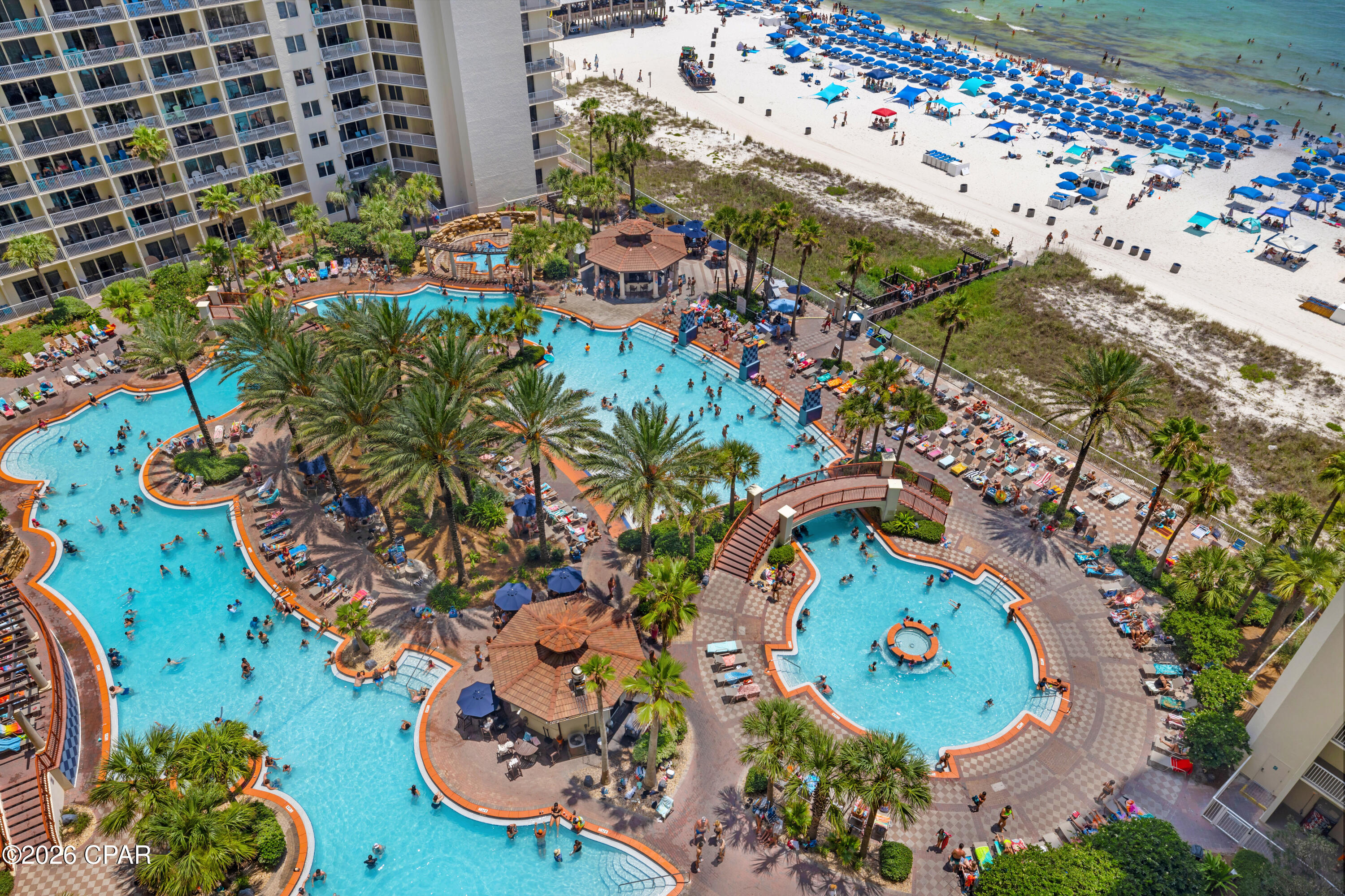RARE TYPE F FLOOR PLAN. DEEDED PARKING. FRONT DOOR RIGHT BY THE ELEVATOR.

Shores of Panama 1410 is a rare Type F floor plan in Panama City Beach, offering deeded parking, a front-door location right by the elevator, and a furnished setup ready for continued rental use. This one-bedroom plus bunk layout includes a cozy living area with a flat-screen TV, dining area, luxury vinyl plank flooring through the main living spaces, and tile flooring in the kitchen and bathrooms.

The kitchen features granite countertops, two refrigerators, and a front-load stackable washer and dryer. Near the entry, a spacious bunk area is positioned along the hallway with a convenient half bathroom nearby. The primary suite includes a king-size bed and a private full bathroom.
The balcony is furnished with Polywood high-top table and chairs, creating a comfortable outdoor setup overlooking the resort setting. Additional details include a deeded parking space on the 7th floor, water heater from 2016, and HVAC from 2018.

Shores of Panama Resort features one of the largest Gulf-front lagoon-style pools in Panama City Beach. The zero-entry tropical pool includes palm-lined islands, fountains, and a spacious hot tub along the resort's private beachfront access. Additional amenities include an indoor heated pool and hot tub, a 24-hour fitness center, and a seasonal poolside Tiki bar.

Located in the heart of Panama City Beach, Shores of Panama places dining, shopping, and entertainment nearby. Pineapple Willy's is adjacent to the resort, while Laketown Wharf directly across the street offers dining, retail, and entertainment options including Wharf Seafood Buffet, The Candymaker Ice Cream Shop, PCB Pizza, In Cahoots, The Press, The Bun Lab, 810 Billiards & Bowling, salon services, and more. Panama City Beach has also welcomed newer attractions and entertainment venues including Dolly Parton's Pirates Voyage Dinner & Show, Topgolf, McGuire's Irish Pub, and Tootsie's Orchid Lounge.

The same owner is also selling unit 1408 (MLS 792192), positioned nearby on the same floor. For guests traveling together, the close front-door proximity creates a convenient two-unit setup with the same elevator access, separate private spaces, and more time together without being spread across the resort.

HOA dues are $3,507.11 per quarter. One special assessment payment remains in the amount of $1,218.04 (4th quarter of 2026) Approximate Gross rental income was $25,000 in 2024, $20,000 in 2025 when the balcony was closed for repairs, and $22,400 year-to-date through the end of June 2026. 

All information, rental income, HOA fees, assessments, measurements, and property details are deemed reliable but not guaranteed; buyer to verify if important.