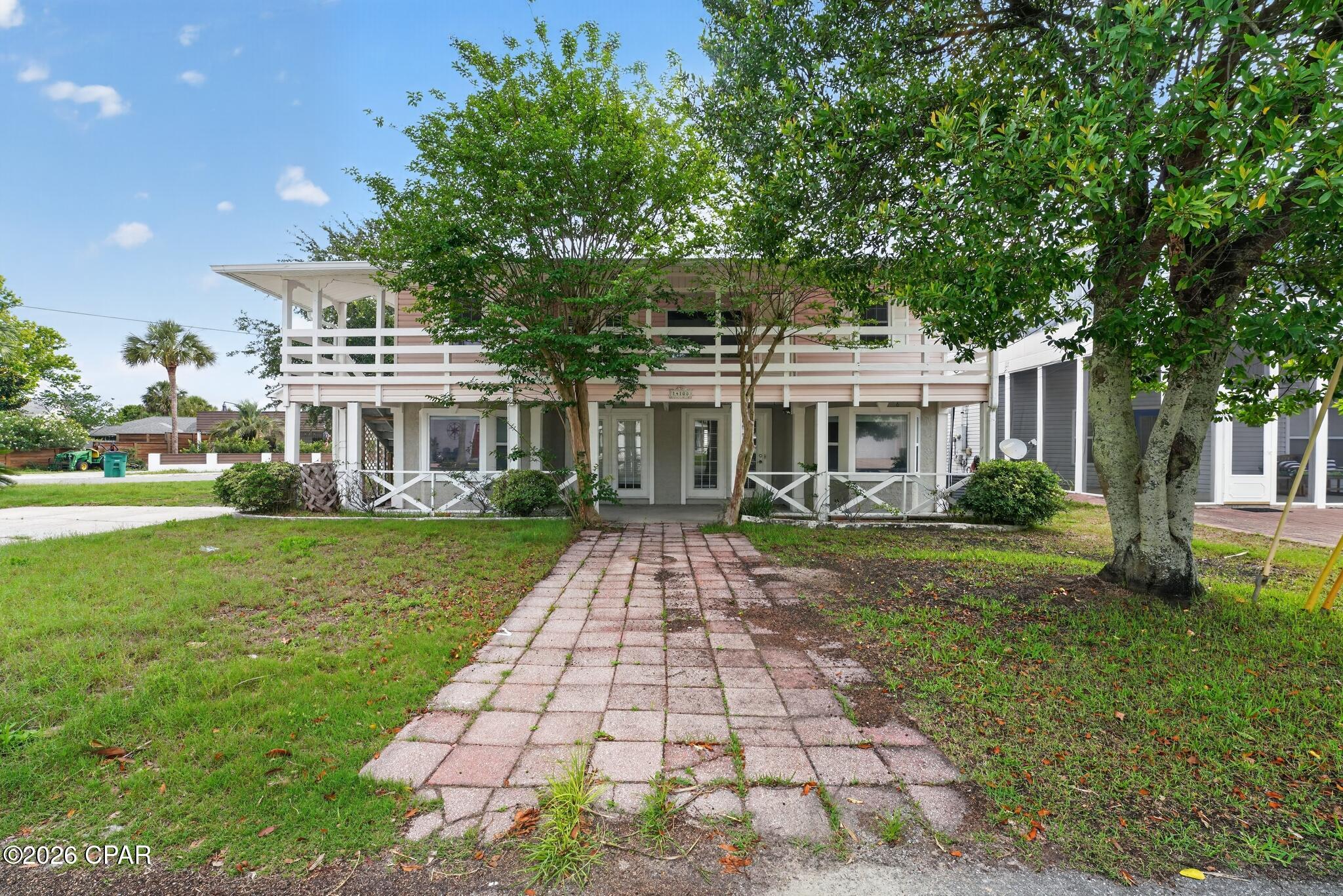 PRIVATE BEACH ACCESS.....4 bedroom 3 bath home in the Bid-a-wee area of Panama City Beach. 2 large porches. This 2 story home has a large Master bedroom & Master bath downstairs as well as a spacious living room as well as an additional full bath. The 2nd floor has 3 bedrooms, dining nook, cozy sitting area, full bath, kitchen and laundry closet.  Extra storage building also available. Close to shopping and access to the bid-a wee community's gated beach access.