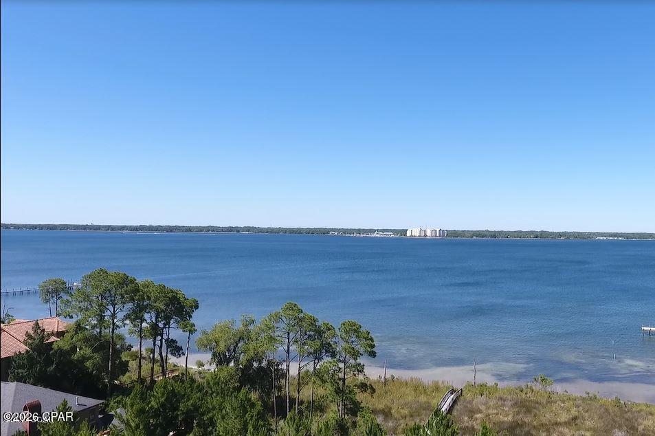 Don't miss your chance to own this magnificent waterfront lot in The Preserve on the Bay. With the expansive water front and the preserved nature areas, the Preserve is the most unique community on Panama City Beach. This large homesite is almost half an acre and has  panoramic water views of St Andrews Bay. Build your dream home and dock for easy boating in the bay or gulf! The Preserve is gated and features 24 hour roving security. It is just minutes away from all the restaurants and attractions offered on Panama City Beach yet it is quiet and secluded!