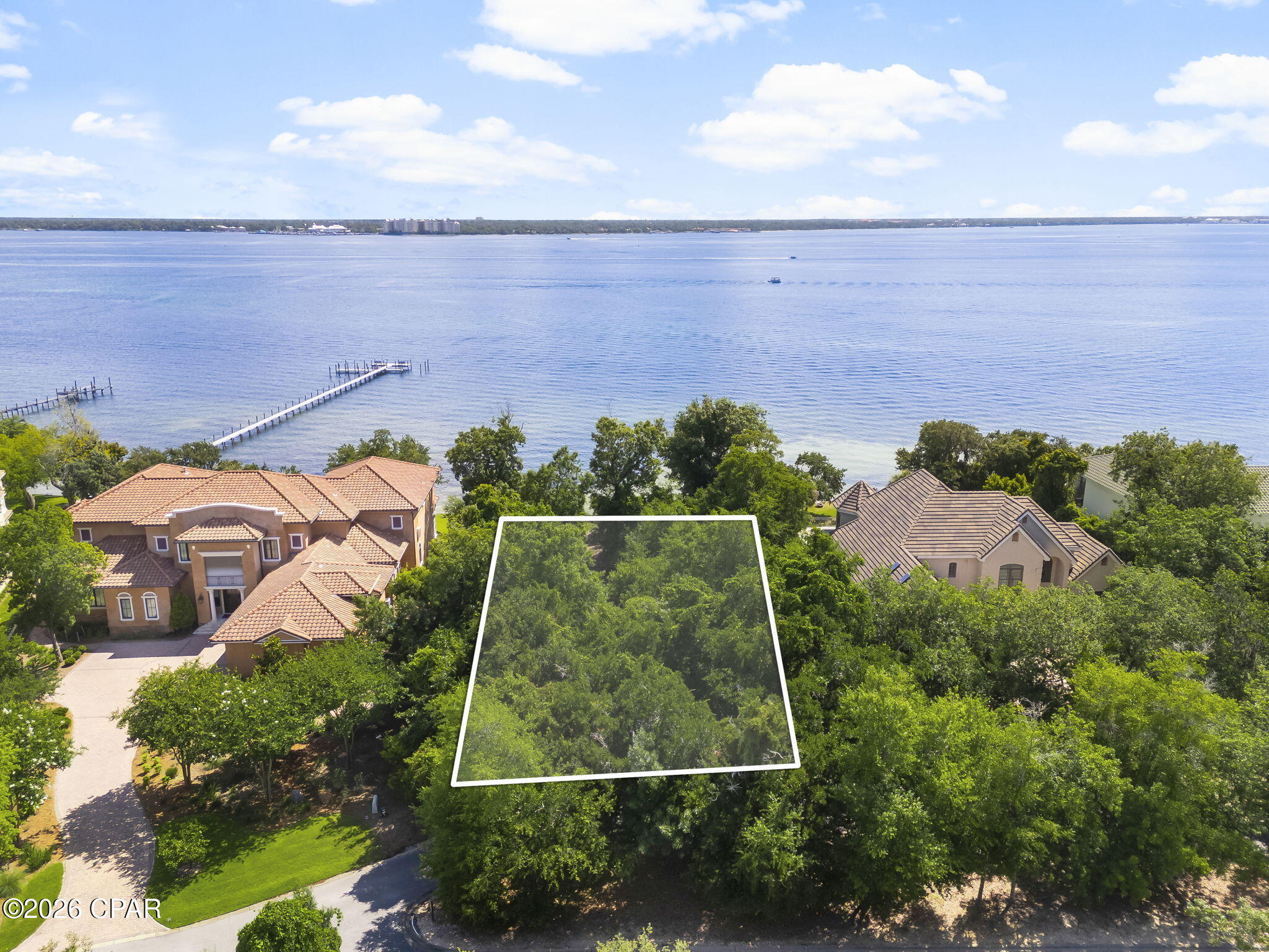 Don't miss your chance to own this magnificent waterfront lot in The Preserve on the Bay. With the expansive water front and the preserved nature areas, the Preserve is the most unique community on Panama City Beach. This large homesite is almost half an acre and has  panoramic water views of St Andrews Bay. Build your dream home and dock for easy boating in the bay or gulf! The Preserve is gated and features 24 hour roving security. It is just minutes away from all the restaurants and attractions offered on Panama City Beach yet it is quiet and secluded!