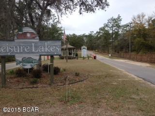 Welcome to the gated community of Lesisure Lakes, about 30 minutes north of Panama City. The subdivision offers activities for the entire family including 2 lakes, 2 boat ramps, fishing, boating, kayaking, swimming pool, pavillion with restrooms and rental kitchen, basketball and tennis courts, a playground for toddlers, and a picnic area. Each lot owner has a code to get through the security gate, and live guards are on duty weekdays. This 1.7 acre lot is off Leisure Lakes on the east side of the development. It is flat with plenty of shade trees and ready for your home, or would make a good investment.