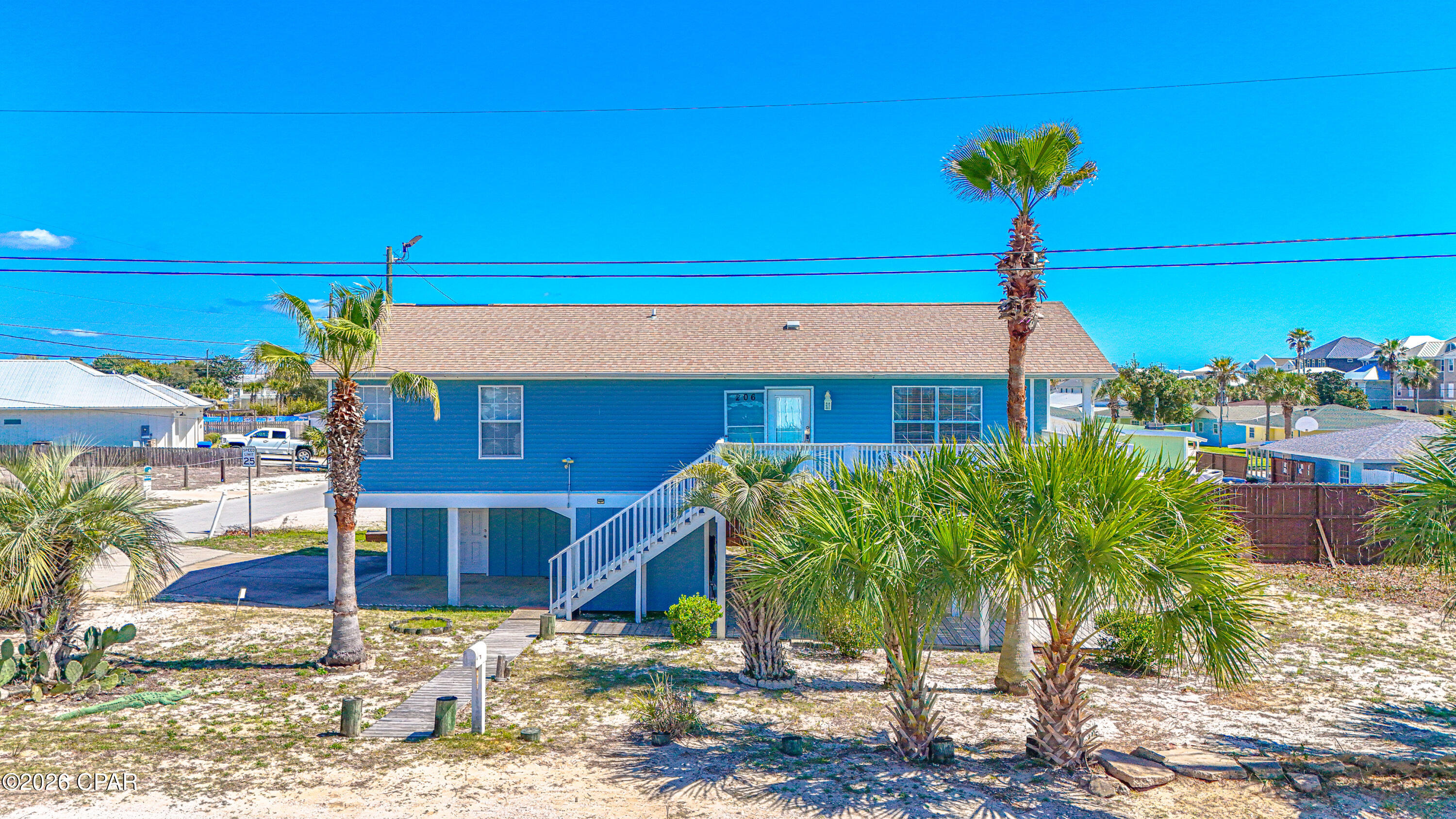 Are you dreaming of a place near the beach with income potential? If so, 206 Shasta Street is definitely worth a look. Located in the desirable Kiska Beach community on the quiet west end of Panama City Beach, this unique property offers two separate living quarters and is just 500 feet from Beach Access 92!  The upstairs level features a 3 bedroom, 2 bathroom layout with a spacious porch where you can enjoy peek-a-boo Gulf views and coastal breezes. Downstairs, you'll find a fully equipped studio apartment with its own kitchen and full bathroom, making it perfect for guests, extended family, or short-term/long-term rental income. The home sits on a spacious corner lot in a golf cart friendly community known for its laid-back beach lifestyle. The downstairs area also features a large covered patio with a 17' x 12' storage room that provides plenty of space for beach chairs, bikes, paddleboards, and all your beach toys! Recent updates include a new AC unit and fresh exterior paint in 2024, plus a roof replacement in 2016. Inside, there is no carpet, making cleanup easy after long days at the beach. One of the best things about this home is the location! You're just minutes from Carousel Supermarket, Thomas Donuts & Ice Cream, the new Aldi, Publix, and Pier Park, with 30A only about 3 miles away. Northwest Florida Beaches International Airport is also just 25 minutes away, making travel simple for owners and guests alike. Whether you're looking for a primary residence, second home, or a rental investment, this west end beach property offers flexibility, Florida charm, and an unbeatable location. Adding a pool? not  an issue sewer on Shasta west of home and on Bataan.