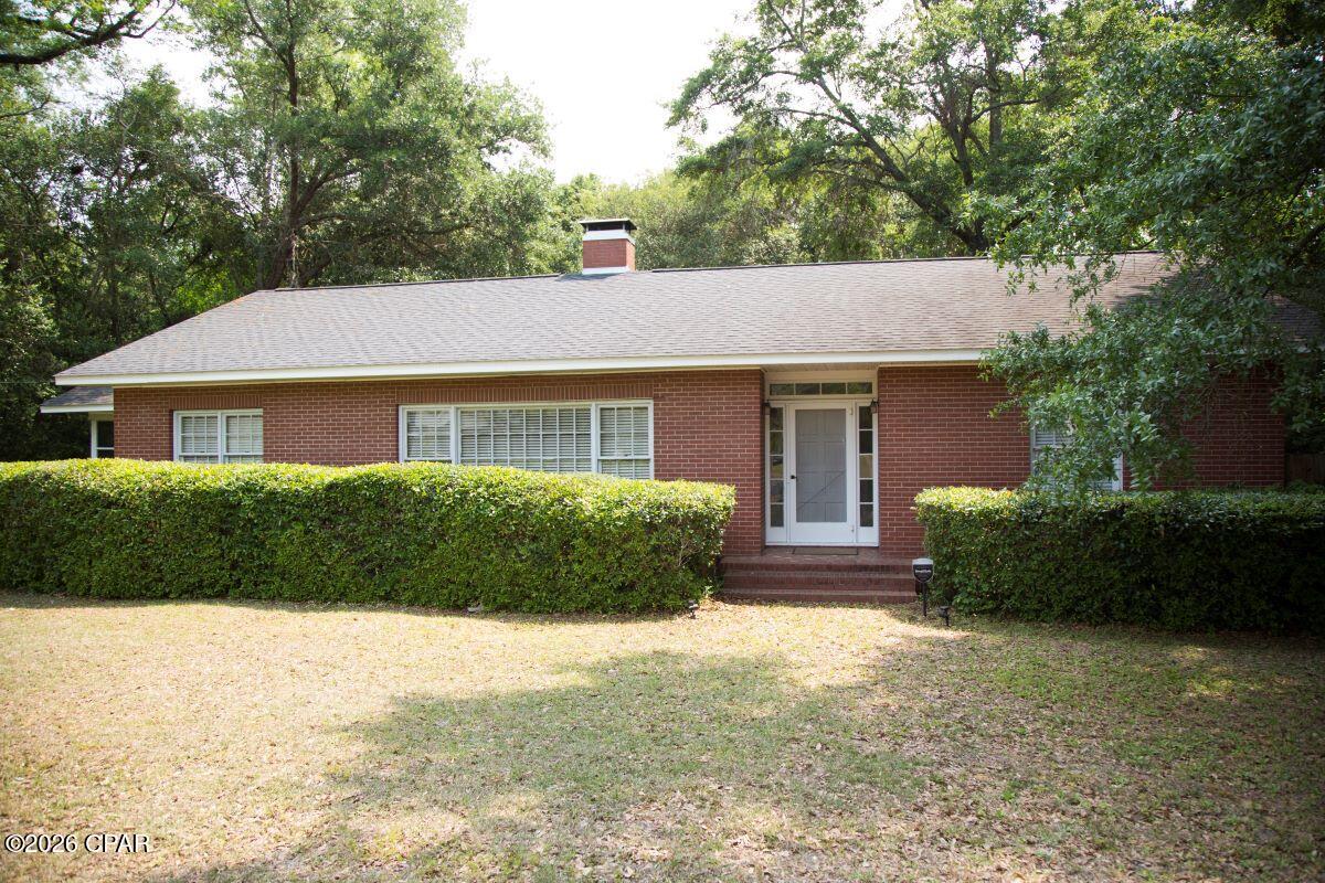 $270,000. PRICE IMPROVEMENT!! Step back in time in this charming 1940 solid brick home with 1914 s.f. of living space, including 3 BR's, 2 baths, spacious eat-in kitchen, separate dining room, and separate living room with fireplace, plus 12' x 22.5' screened porch with terrazzo floor. Lovely original hardwood floors grace the entire home, except in the kitchen area and bathrooms. The kitchen has an electric stove and refrigerator with ice and water in the door. Brand new water heater installed in February. The french doors between the dining room and living room add a nice, nostalgic touch. Children or pets will find plenty of space to run and play in the large privacy-fenced back yard that is very well-shaded. The family can also enjoy grilling/eating outside on the NEW 12'x12' concrete patio adjacent to the back porch. This charmer is situated on over an acre in a quaint little town, with city water, sewer, and garbage collection, and it fronts on a U.S. Highway just 15 minutes from Florida's Capital City of Tallahassee. $270,000.
