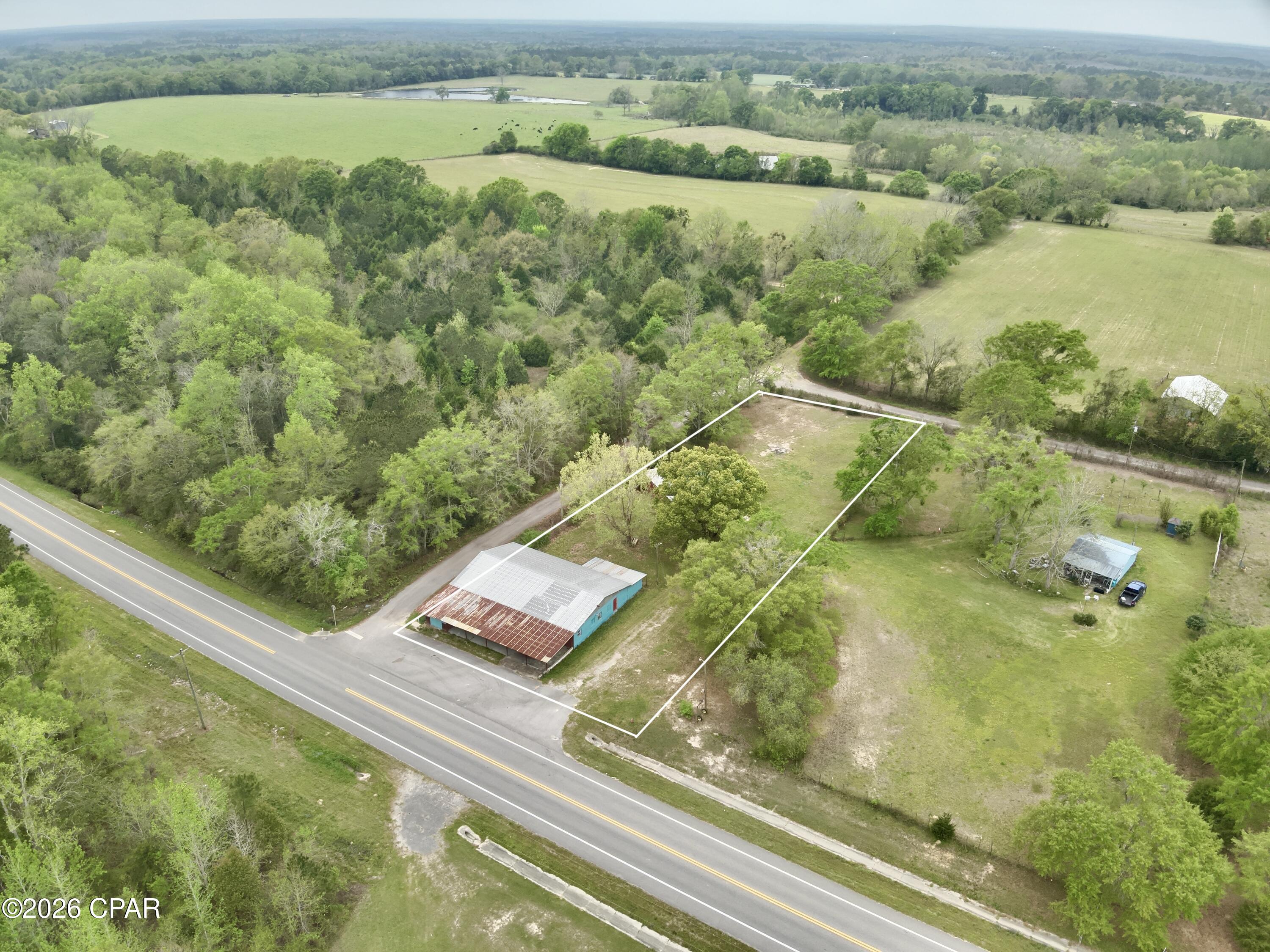 Commercial property for sale on Hwy 79 in Esto Florida - Northern Holmes County.  Main building has previously been used as a bar or entertainment venue - 4357sqft w/ small kitchen, and customer bathrooms.  

Extra enclosed pole barn in the back is used as a hobby mechanics shop.  1.1acre lot that has frontage on Hwy 79 and 2 side streets.

Spray foam insulation and HVAC