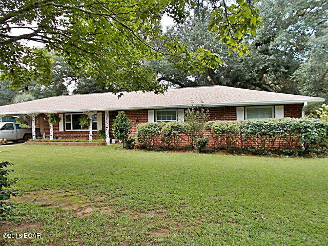 Brick home on 8 acres of land complete with an in-ground pool, stocked fish pond with dock.This home has a large living room with plenty of natural light, bright white kitchen, side by side ref 2 years old with tile floors,hall carpet replaced in 2013. Bright open sun room and large bonus room. This home has been updated roof replaced in 2010, salt water concrete block pool, block pool house, separate well for pool, gas log fireplace. All double insulated windows, large metal workshop, large block outbuilding, massive oaks, plenty of fruit trees and grape vines,pecan trees, privacy fence and electric automatic privacy gate, lots of extra features with this home, all on a paved road just minutes from the Grand Ridge I-10 exit, ideal for working in Blountstown, Mariannna, or Tallahassee. Call agent to view this home.THE CHANDELIER IN THE LIVING ROOM WILL NOT CONVEY.
