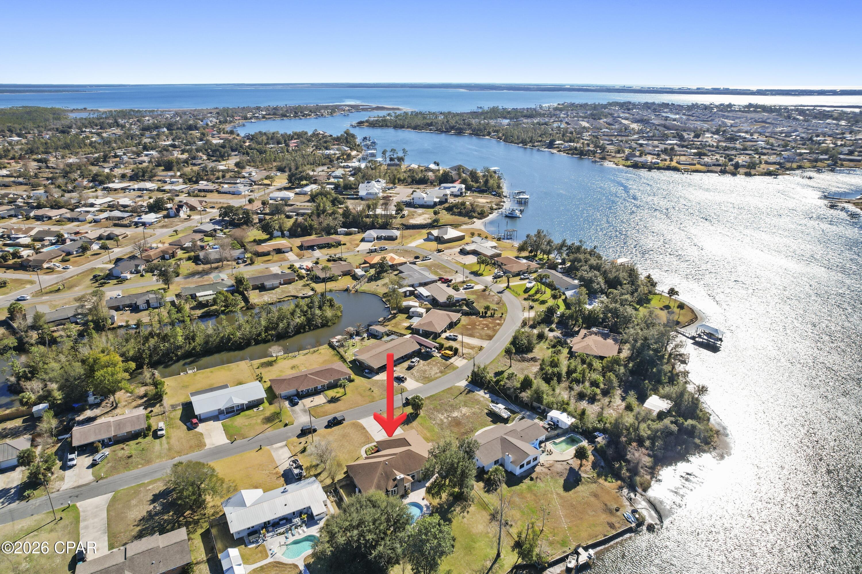 FABULOUSLY AFFORDABLE, DEEP WATERFRONT, WITH ACCESS TO THE GULF AND EVEN SOUTH AMERICA, IF YOU LIKE!! Meticulously maintained, this beautifully built home has a great layout to enjoy the water views from almost every room. The boat house and dock has running water available and has direct access to a deep channel that will get you to the Gulf!  Stand in the huge, beautifully remodeled kitchen and watch the pelicans dive for their lunch. You will also find incredible views from the living room, dining room, master bedroom and the 2nd bedroom! The expansive master bedroom has a sliding glass door to access the swimming pool. The master bath has a jetted tub, separate shower, dressing area and a huge walk-in closet, from where you can access the laundry room. The laundry room has a utility sink and lots of cabinets for storage, plus a large countertop for folding laundry.  It also doubles as a safe room in inclement weather.  Hurricane shutters help protect the home from high winds and flying debris. Floor to header braces secure the garage doors in bad weather. Home is wired for an emergency generator with 7500 watt generator. The 2nd bedroom is ensuite with access from the bathroom to the back porch and pool and has 2 large closets.  Sweet breakfast nook on the front of the kitchen, in a bay window, gives you views of your front yard. The garage is an oversized 3 bay with storage above in the attic.  Extensive list of amenities available. Age, lot size, rm sizes, sq ft are estimates. Please measure if concerned.