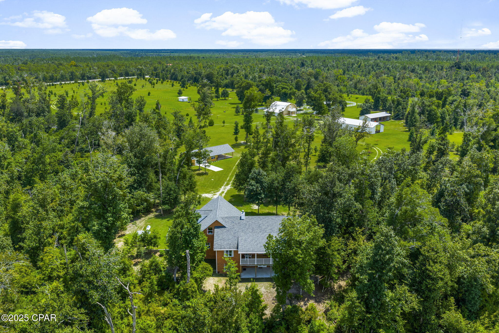 'CURRENTLY UNDER CONTRACT, SELLER WILL CONSIDER BACKUP OFFERS'
100-Acre Equestrian Estate with Creek, Luxury Home, Barn, & Barndominium.
Exceptional 100-acre estate with creek frontage, luxury residence, and equestrian facilities - offered as three total parcels. Immaculately maintained grounds feature rolling pastures, rare trees, and a scenic creek winding through the property. 

Parcel 1 - 35 Acres
The main residence is a showcase of state-of-the-art construction with 2,962 heated/cooled sq ft, offering 5 bedrooms, 3 full bathrooms, and a gourmet kitchen with cherry soft-close cabinets, granite, stainless appliances and a large gathering island. The 30' wide balcony captures breathtaking views of the surrounding landscape, while the owner's suite features a spa-like ensuite bathroom with a soaking tub, walk-in shower, and dual walk-in closets. The main level is a split bedroom floor plan with engineered hardwood flooring throughout the main living areas and bedrooms. The two additional bedrooms, and full bathroom with double vanities are on the opposite side of the home from the owner's suite.
The second floor offers two bedrooms and a full bathroom, ideal for guests or family, while the main level ensures room to spread out.
A 60' unfinished basement on a solid concrete slab provides endless possibilities, complete with a covered porch and windows. Every detail has been thoughtfully designed, including a fire suppression system, central vacuum, Generac whole-house generator with auto start, and Culligan water filtration system. A spacious three-car garage completes this home. 

An immaculate workshop provides versatility with a two-car garage, farm style sink, refrigerator, and a full bathroom - perfect for a hobby room, separate office/home business, or additional storage.

Parcel 2 - Adjoins parcel 1 to the north with approximately 30 Acres of heavily wooded grounds, and approximately 975 ft of creek frontage, perfect for trails, hunting, or privacy. 

Parcel 3 - 35 Acres
The southernmost parcel serves as the equestrian and agricultural heart of the property. Here you'll find the barndominium, equestrian barn, fenced pastures, and multiple equipment storage buildings. The barndominium offers approximately 1,444 sq ft of living space, with a full kitchen, half bath on the main level, and an upstairs master suite with a balcony featuring a spa-style bathroom, double vanities, dual walk-in closets, a spacious living room, and bonus/flex space.
Equestrians will delight in the barn facilities, which include three horse stalls with pivot feeders, a wash station, and an automatic fly-spray system in the stalls. The barn also has an oversized laundry facility, feed room, and back-up generator. The pastures are fully fenced with a run-in shed, raised covered feeding area, and two additional storage buildings for equipment behind the barn. 
Beyond its exceptional amenities, the estate is enhanced with over 2,000 trees thoughtfully planted across the landscape, creating a one-of-a-kind natural sanctuary. A gated main entry and two additional gated access points ensures both privacy and convenience for the three different parcels offered. 

A rare opportunity to own a luxury creekfront equestrian estate designed for both comfort and functionality.

*All measurements and information approximate, please verify if important.