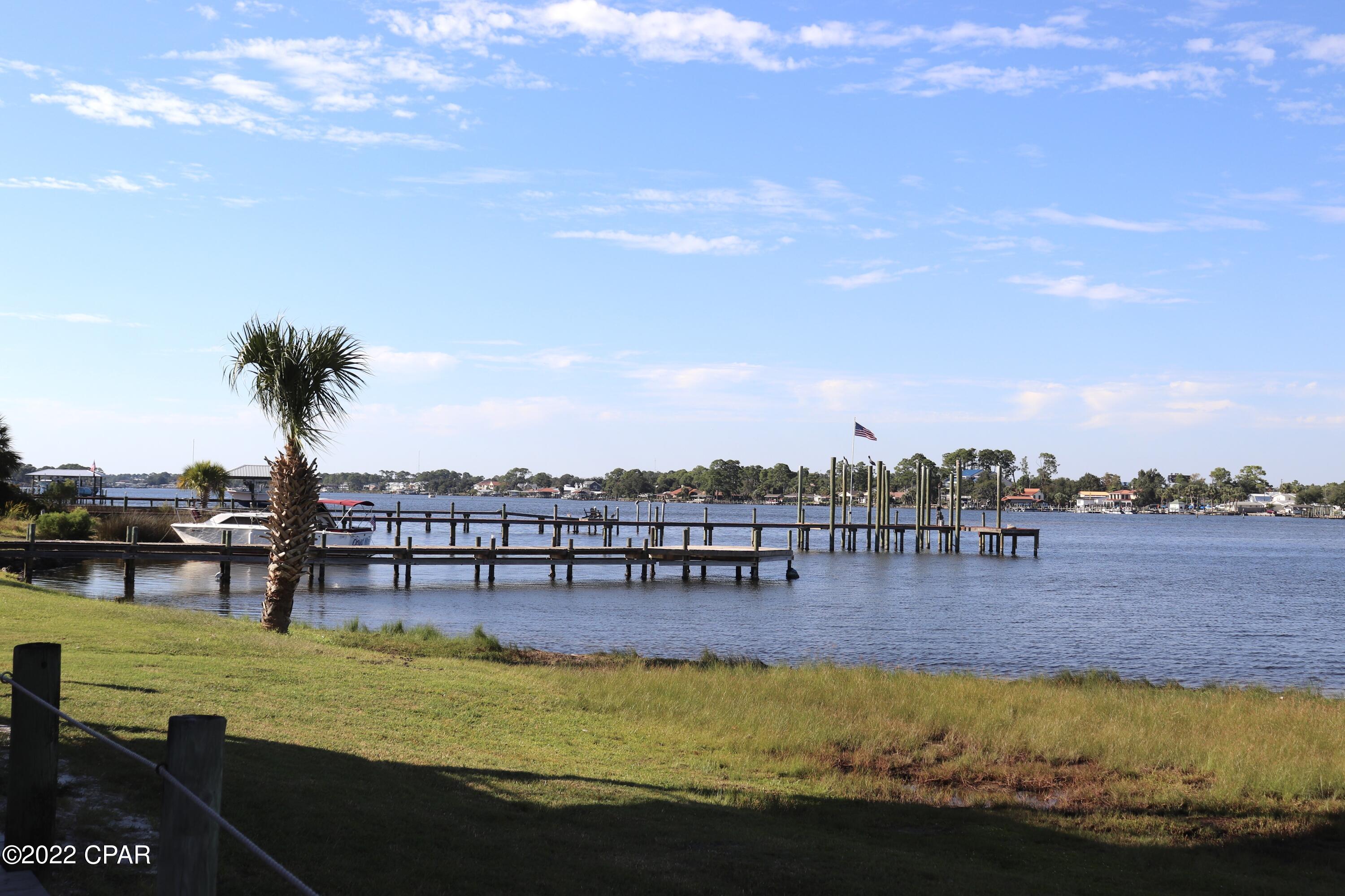 Looking for a place to come to The World's Most Beautiful Beaches? This super cute condo would be perfect!  It has a community pool, a boat dock and also offers additional parking for your boat storage. It's just a quick boat ride to Shell Island or a quick ride to the pass to go out into the Gulf of MEXICO! This unit offers a full kitchen with new appliances, a breakfast bar that's open to the living area. The niche in the hall could be used for an office space or a bunk bed. The unit also has a full bath, a stackable laundry closet and a covered deck. There is plenty of shopping, dining and entertainment nearby! This condo is just a little more than a half of a mile to a public beach access! Ask about owner financing!