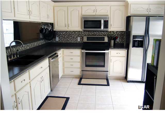 If you enjoy cooking, you will delight in this kitchen. Make an appointment to see this recently reduced quality home built by a reputable local builder, conveniently located in the heart of Lynn Haven, just off Hwy 390, minutes to schools, shopping and restaurants. This home has tons of upgrades, to include: a new AC, installed in 2014, hardwood flooring, kitchen with stainless steel appliances and back splash, cabinets, for your convenience, in the laundry room and a screened in porch that overlooks the backyard. Split floor plan gives the master a little extra privacy. Garage has been converted into a 20x10 heated and cooled office and a 20x10 storage area. All information contained herein is intended to be correct; however, buyer assumes complete responsibility for verification of