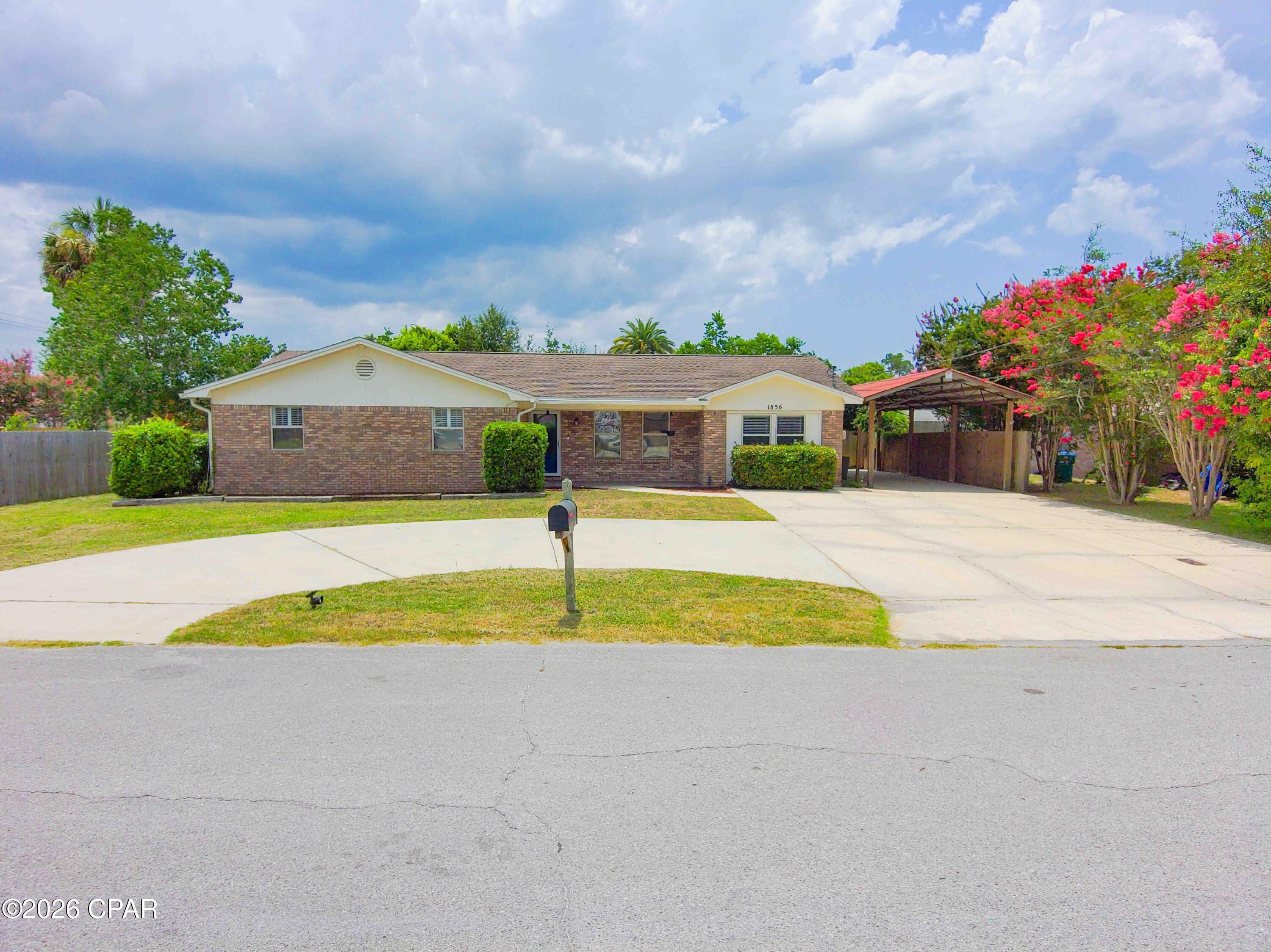 **NEW PRICE! Seller Offering $15,000 Toward Buyer's Closing Costs, Interest Rate Buydown, or Approved Upgrades!** For qualified buyers, this incentive could be used toward a 3 2 1 interest rate buydown, potentially reducing the first year's estimated mortgage payment only to approximately $1,600 to $1,700 per month. Buyer to verify financing terms and payment estimates with their lender.

This 4 bedroom, 3 bath home offers approximately 2,042 square feet of living space on a 0.28 acre fully fenced lot with no HOA, short term rentals permitted, golf cart access to SweetBay, and less than 10 minutes from Panama City Beach. **Property Video Available!** Opportunities offering this combination of location, flexibility, and lifestyle near the rapidly growing SweetBay community are becoming increasingly difficult to find.

Located in a quiet, low traffic neighborhood in unincorporated Panama City, residents in this area can legally drive a street legal golf cart directly to SweetBay Town Center to enjoy Publix, restaurants, waterfront gathering spaces, parks, community events, and the popular Sunday Farmers Market, all without crossing major highways. With continued residential and commercial growth surrounding SweetBay, this area continues to attract homeowners, second home buyers, and investors alike.

Inside, you'll find fresh paint in select areas, durable flooring, newer kitchen appliances including the oven and dishwasher, and a flexible floor plan designed for a variety of living arrangements. A separate den with fireplace creates an ideal second living area, media room, or gathering space, while the converted garage serves as a private fourth bedroom suite complete with its own full bathroom, making it perfect for guests, multigenerational living, a home office, or hobby space.

Outside, the property is designed for both functionality and convenience. The circular driveway provides ample parking, while the approximately 14 x 38 covered carport with lighting is ideal for a boat, small RV, trailers, workshop space, or additional covered vehicle parking. Additional exterior features include a covered back patio, storage building, reinforced gates providing easy access throughout the property, and a spacious fully fenced backyard.

Whether you're searching for a primary residence, second home, or investment property, this location offers exceptional convenience with SweetBay Town Center, University Academy, hospitals, shopping, Lynn Haven, Panama City, and Panama City Beach all just minutes away.

As an added bonus, qualified buyers may have the opportunity to assume the seller's existing VA loan with an attractive 2.5% interest rate, providing a potentially significant financing advantage in today's market.

All information is deemed reliable but not guaranteed. Buyer to independently verify all measurements, features, zoning, intended uses, financing options, and any information deemed important.