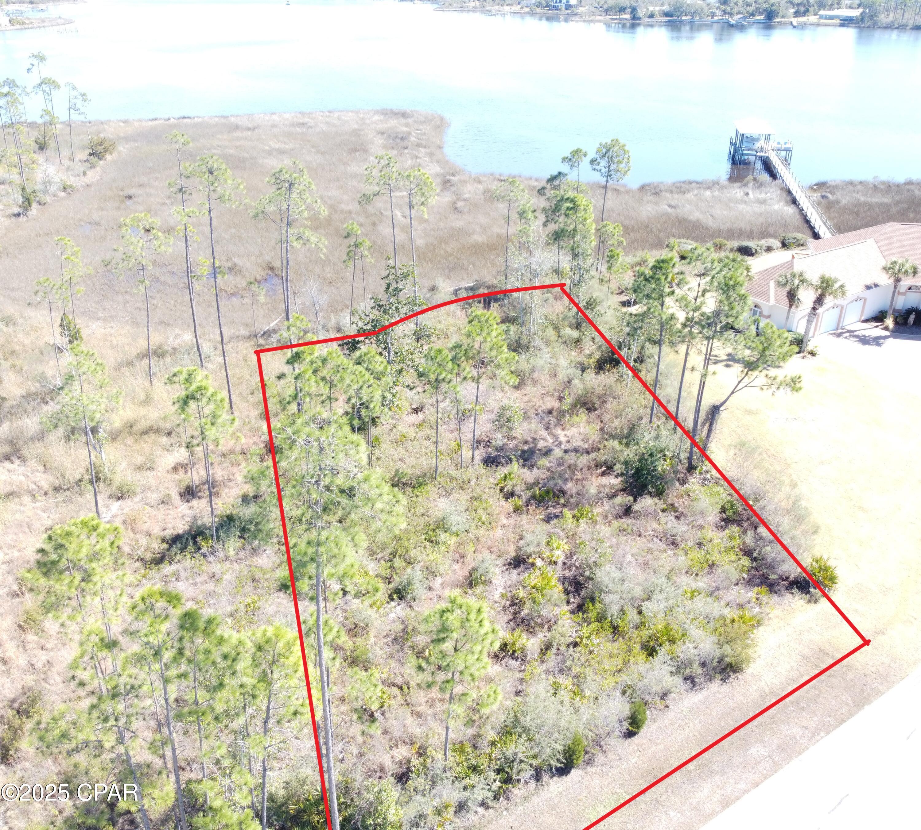 Best priced waterfront in the Panhandle! Spectacular deep water home site in the desirable Laird Bayou. Plenty of space to build your Dream Home. Enjoy panoramic views of Cook and Laird Bayou. Even views of East Bay. Experience true deep water access to accommodate large fishing boats and cruisers. No worries of low tides or low bridges preventing your access to the Gulf of Mexico. If you love bay fishing East Bay boasts some of the best grass flats in the Panhandle. Laird Bayou is a gated waterfront community that features ribbon curbed streets and beautiful custom built homes. Amenities include a Boat Launch w Dock, Pool w Bath House, RV/Boat Storage, and a Mail Kiosk. Laird Bayou offers great proximity to Mexico Beach and Panama City Beach, but is just far enough to escape the traffic and tourism. Schedule your visit today!