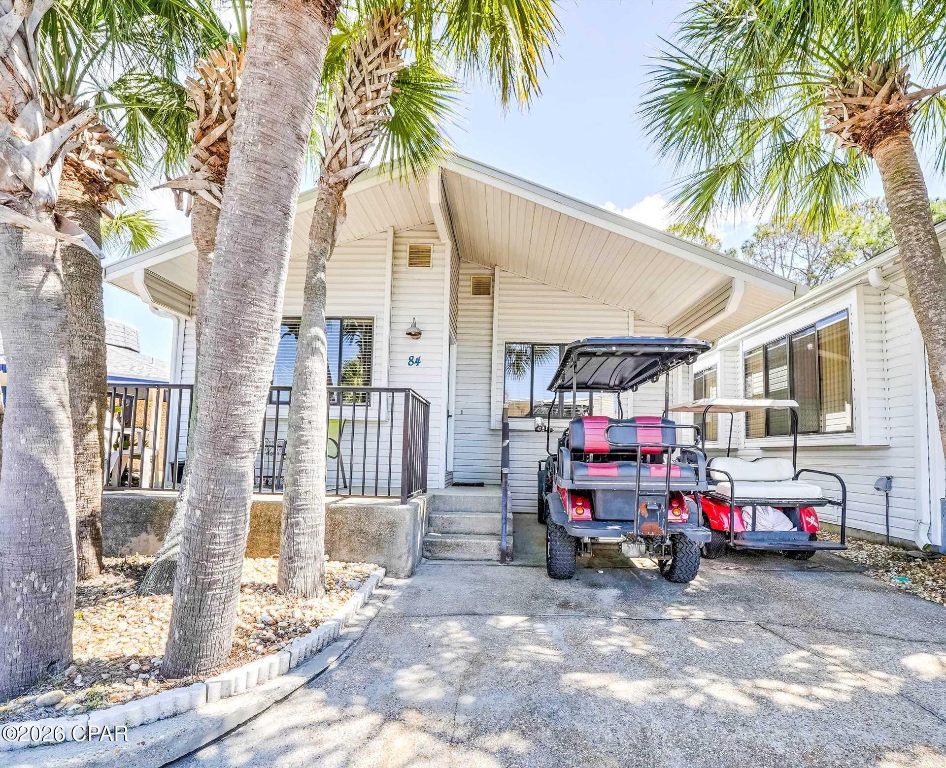 Welcome to your own private coastal retreat in the highly sought-after gated golf-cart community of Venture Out in Panama City Beach! This beautifully maintained 3 bedroom, 2 bath home is one of the larger homes within the community and offers the perfect blend of privacy, nature, and beach lifestyle with the rare bonus of having St. Andrews State Park directly behind the property -- creating a peaceful, natural setting that is hard to find within the resort.

This spacious and inviting home features an open-concept floor plan with warm coastal touches throughout. The large living area offers vaulted ceilings, abundant natural light, and plenty of room for relaxing or entertaining. The kitchen includes ample cabinetry, generous counter space, and a functional layout that opens seamlessly into the living spaces.

The oversized primary suite provides a comfortable retreat with plenty of space, while the additional bedrooms and baths offer flexibility for guests or rental potential. Offered furnished, this home is move-in or rental ready.

Step outside to enjoy one of the property's standout features -- the expansive outdoor patio area overlooking the natural beauty of St. Andrews State Park. Enjoy privacy, tropical landscaping, and the peaceful surroundings while still being just a short golf cart ride to the beach, pools, marina, and resort amenities.

Located in Venture Out, one of Panama City Beach's premier gated waterfront communities featuring:

Private beach access to the Gulf of Mexico
2 swimming pools
Private boat ramp
Fishing pier on Grand Lagoon
Tennis, pickleball & basketball courts
Playground & picnic areas
24/7 gated security
Golf-cart friendly community

Whether you are looking for a primary residence, second home, or vacation rental investment, this unique property offers an incredible opportunity to own a larger home with unmatched backyard privacy inside Venture Out!