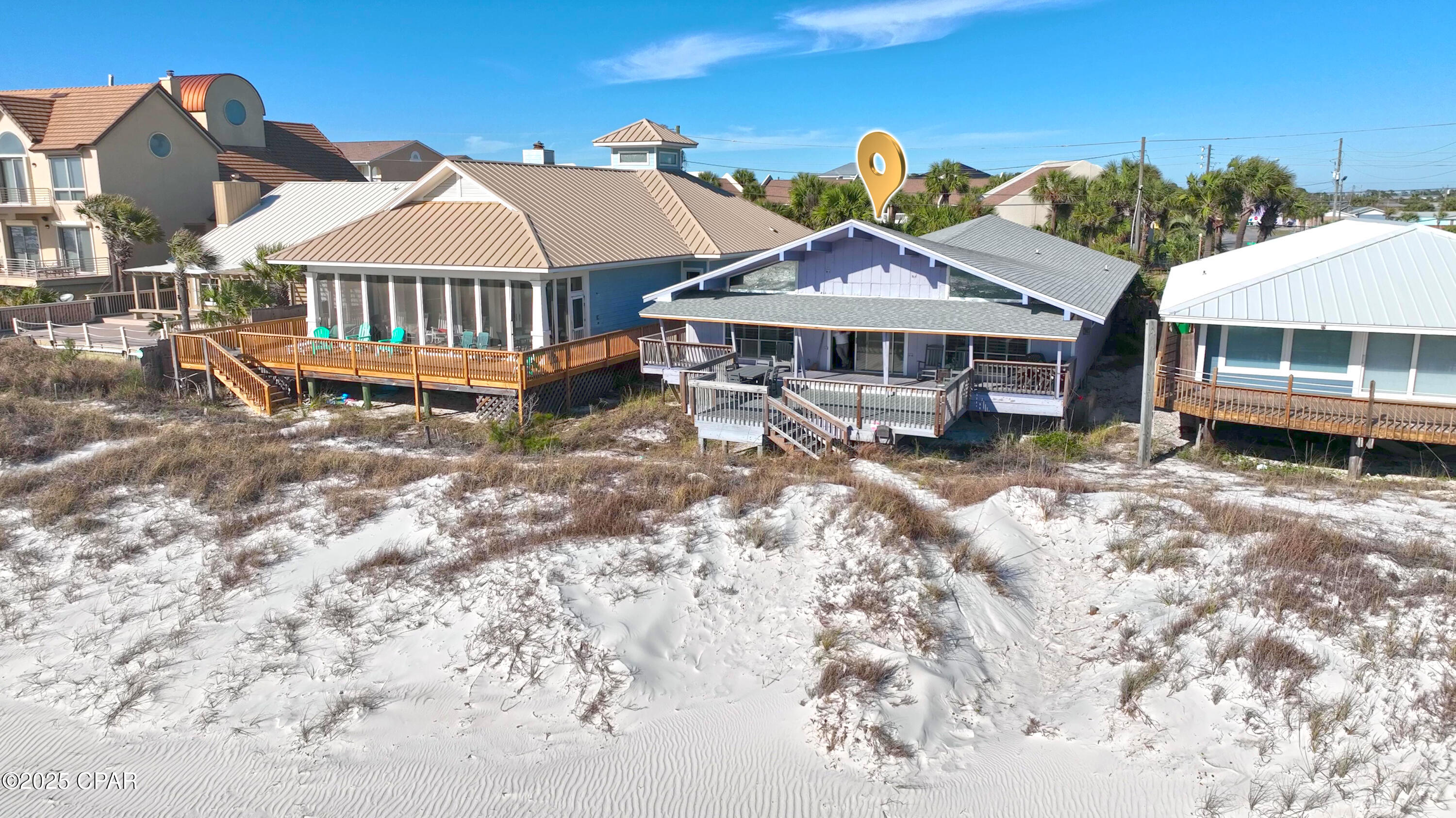 ***CURRENTLY UNDER CONTRACT, SELLER WILL CONSIDER BACKUP OFFERS***Rooney's Beach House.  This beach house has been entertaining families on Panama City Beach for years.  The house comes in at just over 2,144 sq.ft. of living area according to the appraisal and features 3-bedrooms and 2-baths.  (there is plenty of unused space that could easily become the 4th. bedroom and even a 3rd. bathroom with very little remodeling needed.  This beach house overlooks the sparkling white sand and the crystal clear waters of the Gulf.  The living area boasts an open floor plan to take advantage of the wonderful views.  The kitchen, dining area, and family room all look out over the beach view.  The oversized kitchen has plenty of counter space and cabinets.  A large kitchen island offers more prep and storage space.  The house currently has sleeping arrangements for 8  and as indicated in the remarks earlier there is plenty of room to put in an additional bedroom or bunkroom.
A new roof and air conditioner in the past year should give you years of worry free living.  There is a large covered deck area as well as a large open deck area, all looking out over the World's Most Beautiful Beaches.  There is covered parking in both the garage and carport as well as extra parking in the driveway.  Both the garage and carport are large enough to hold a golf cart.  A workshop and storage area are also in the garage.   Location, location, location.  You are in walking distance to St. Andrews State Park as well as most of the area's marinas with their fishing, diving, and sightseeing fleets.  The world famous Schooners Beach Restaurant is just a couple hundred yards away.  Whether you are buying for investment or for family use our area has lots to offer our residents and visitors.  Imagine sitting on your back deck sipping a cool beverage, watching the kids building a sandcastle and watching those magical sunsets.  Life is good.