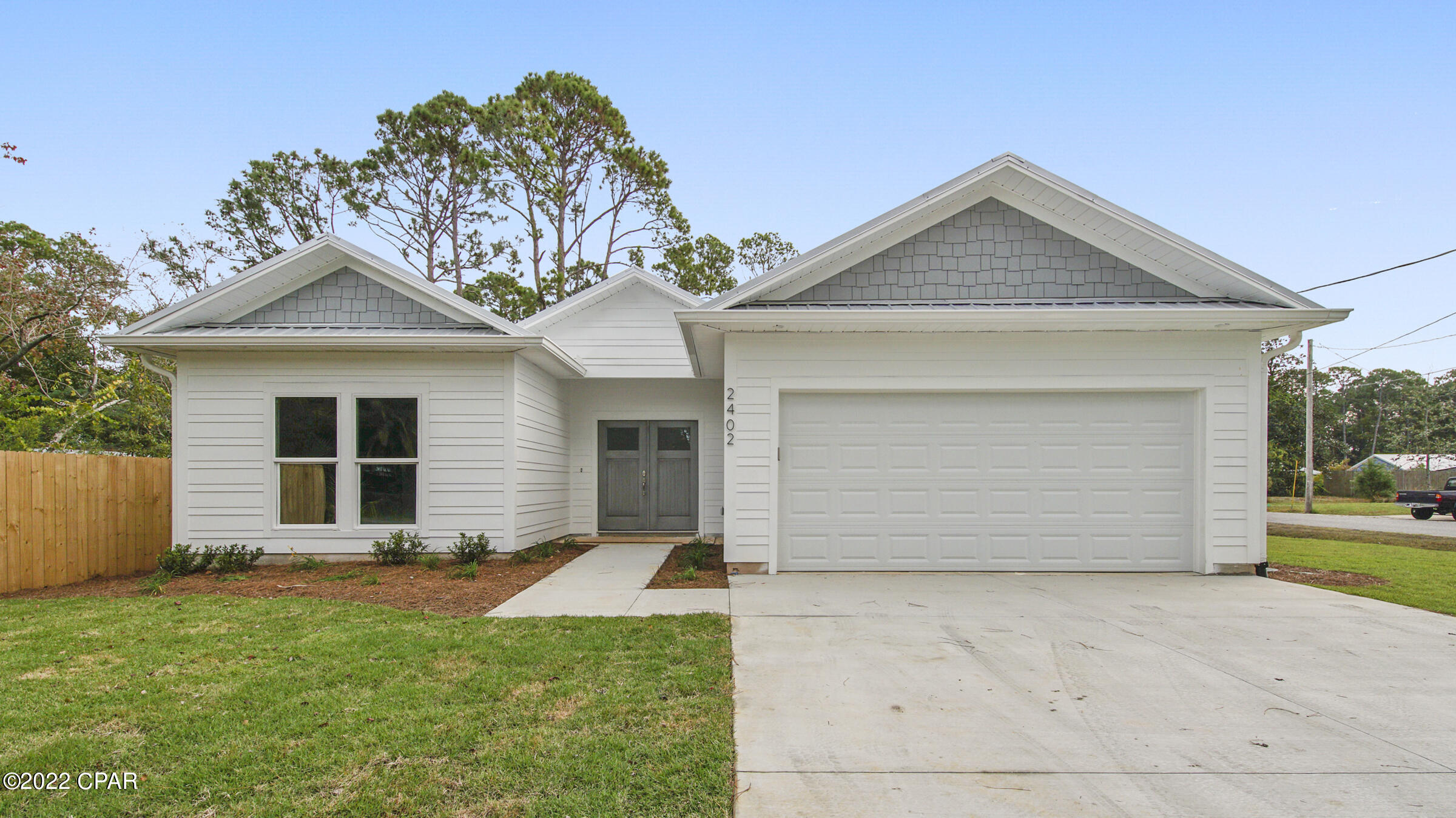 Where to begin with so many HIGH QUALITY features – New construction with room for a POOL, in Panama City Beach! This 4 bedroom/3 full bathroom home is built by a local builder with attention for detail & care. Your new home or rental property is on a large corner lot and purposely positioned to one side for full use of the side yard currently there are 2 sides of 6' privacy fence with the other sides open in case you want to add a pool, additional boat or RV parking. **Seller is offering (with acceptable contract)  $5000 toward driveway expansion, fencing or whatever the buyer's heart desires. Exterior is finished with Hardy Board siding, impact windows, fully foam insulated, metal roof, covered patio, sprinkler system to water the landscaped finishes. Rental Projection up to $55k Inside flooring is wood look tile plank, cabinets are topped with high level quartz, stainless Samsung kitchen appliances master bathroom with oversized tiled shower and separate soaking tub with walk in closet, 3 more bedrooms - one en suite!