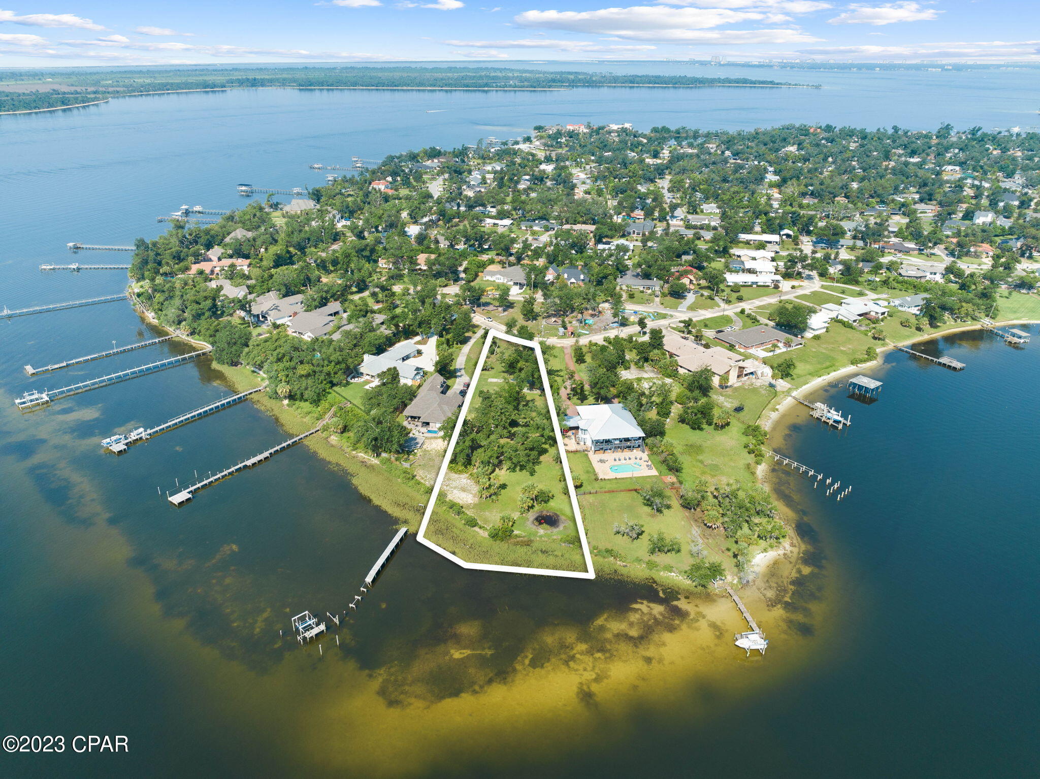 A rare WATERFRONT opportunity with NO HOA is now available to build your dream home in the highly coveted Cove neighborhood! Adorned with hundred year old, mature oak trees and 175' water frontage, this is an idyllic setting featuring unparalleled views of the open Bay. This vacant lot, ready to build, presents an exceptional  canvas for your dream waterfront retreat. This lot boasts an incredible 1.1 acres and is situated across from a neighborhood park. You'll enjoy the highest level of privacy on this estate-sized homesite that is so rare. The lot provides access to newly ran city water and sewer lines at the road along with natural gas. Don't miss your chance to own this PRIME waterfront homesite on Bunkers Cove Road with stunning panoramic views of the Bay, located just 6 miles by boat to the open Gulf of Mexico. Live your best WATERFRONT life fishing, boating, kayaking, and enjoy the purest of Bay views from your backyard.

The seller has begun preliminary home plans for a 2,751 SF single level home offering three bedrooms, three bathrooms, office, bonus room above the three car garage and a remarkable outdoor living area. The plans will convey to buyer but are not engineered or build-ready. The buyer may choose to continue on with the plans at their discretion and cost. Renderings show the home on the lot for visual purposes only. 

The Cove is a quaint neighborhood that features highly desirable waterfront homesites, charming community parks, golf cart-friendly streets and activities year-round! Just minutes from booming downtown Panama City, you'll be just a few miles from farmers markets, a brewery, arcade, fabulous dining, boutique shopping and tons of activities. 

A waterfront opportunity like this doesn't come available often. This is your chance to build your dream home!