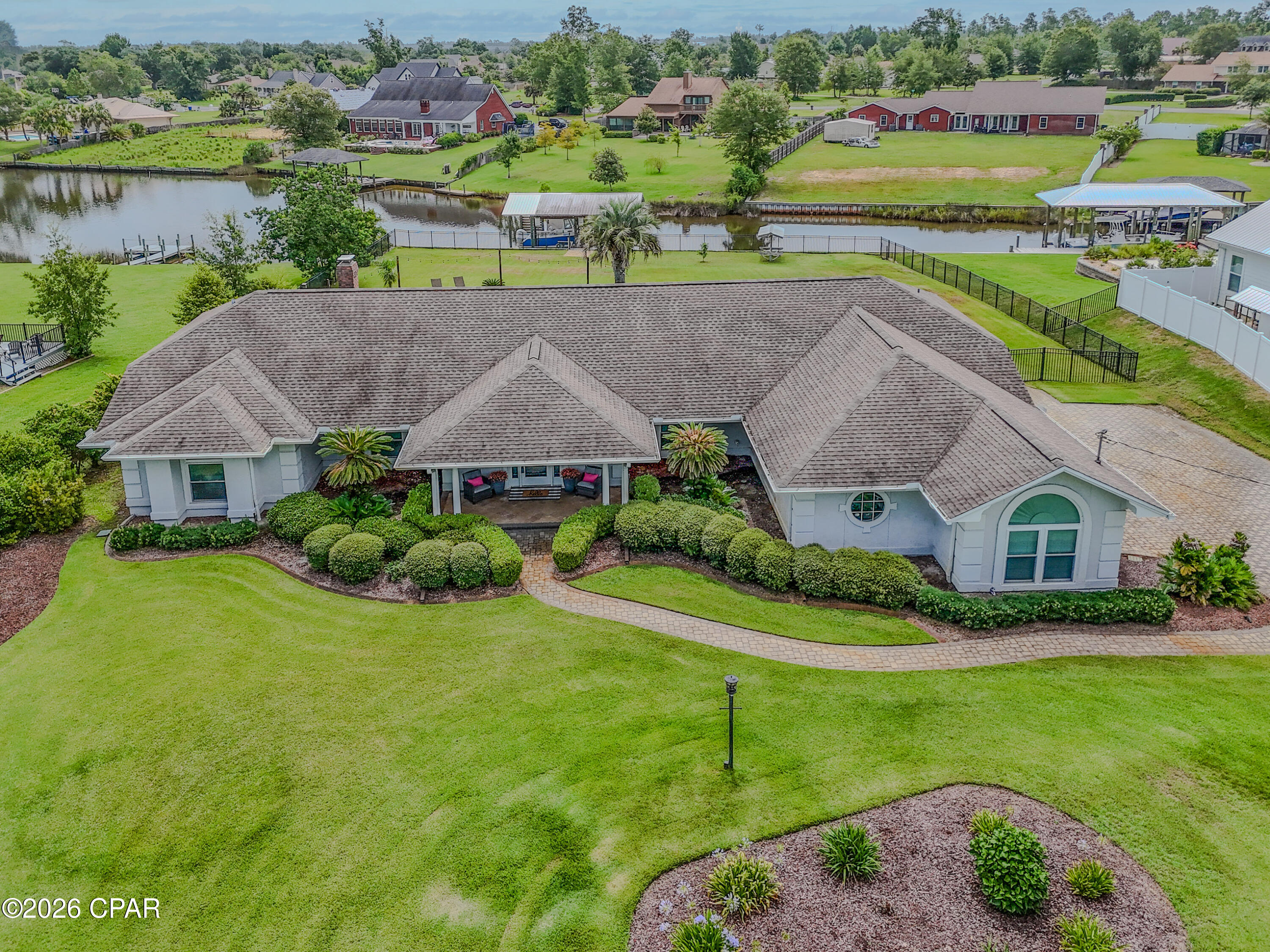 Welcome to your own waterfront paradise on beautiful Mill Bayou, offering direct Gulf access and everything you need to enjoy the Florida boating lifestyle. Situated on over a half-acre, this exceptional 3-bedroom, 2-bath home features a private dock, boathouse, and boat lift capable of accommodating a 25-27-foot boat and an additional lift for a Waverunner-making it easy to enjoy endless days on the water. Inside, you'll love the spacious open floor plan designed for both everyday living and entertaining. The updated kitchen showcases stunning tile backsplash, ample cabinetry, and flows seamlessly into the expansive great room. Anchored by a cozy gas fireplace surrounded by picturesque white brick and custom built-in bookcases, the living space offers warmth, charm, and breathtaking views of the backyard through 3 sets of French Doors. The primary suite is a true retreat, featuring a peaceful sitting area with views of the water and pool, a generous walk-in closet, and a luxurious en suite bath complete with a beautifully tiled walk-in shower and classic clawfoot soaking tub.
Enjoy meals in the formal dining room or the sunny breakfast nook, where walls of windows overlook the sparkling saltwater pool and tranquil waterfront beyond.
Step outside to the large screened and covered patio, the perfect place to relax, entertain, or simply soak in Florida's year-round outdoor living. The oversized backyard is beautifully landscaped with lush green grass and a stunning saltwater pool surrounded by paver decking, creating a private oasis for family and friends. Completing this incredible property is a spacious two-car garage, abundant parking for vehicles, boats, and guests, plus a convenient 30-amp RV hookup. Whether you're boating, swimming, entertaining, or simply enjoying the peaceful waterfront setting, this exceptional Mill Bayou home offers the perfect combination of luxury, comfort, and coastal living.