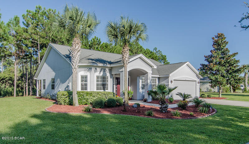 *****BEAUTIFUL PALMETTO TRACE HOME**** If you are looking to live in Palmetto Trace but would also like privacy, this is the home!. This model perfect home sits on a very large .38 acre lot measuring 16,715 sq. ft. The home has recently been upgraded with beautiful wood laminate floors and new paint and landscaping. When the home was built it had over $25,000 of builder upgrades which included a gorgeous gourmet kitchen and beautiful master bathroom. Palmetto Trace is a premier community with sidewalks, planned street scapes, 2 community pools and is golf cart friendly. Just steps from Pier Park and a short golf cart ride to the ''Worlds Most Beautiful Beaches''. DONT LET THIS ONCE IN A LIFETIME OPPRONTUNITY PASS YOU BY!!.