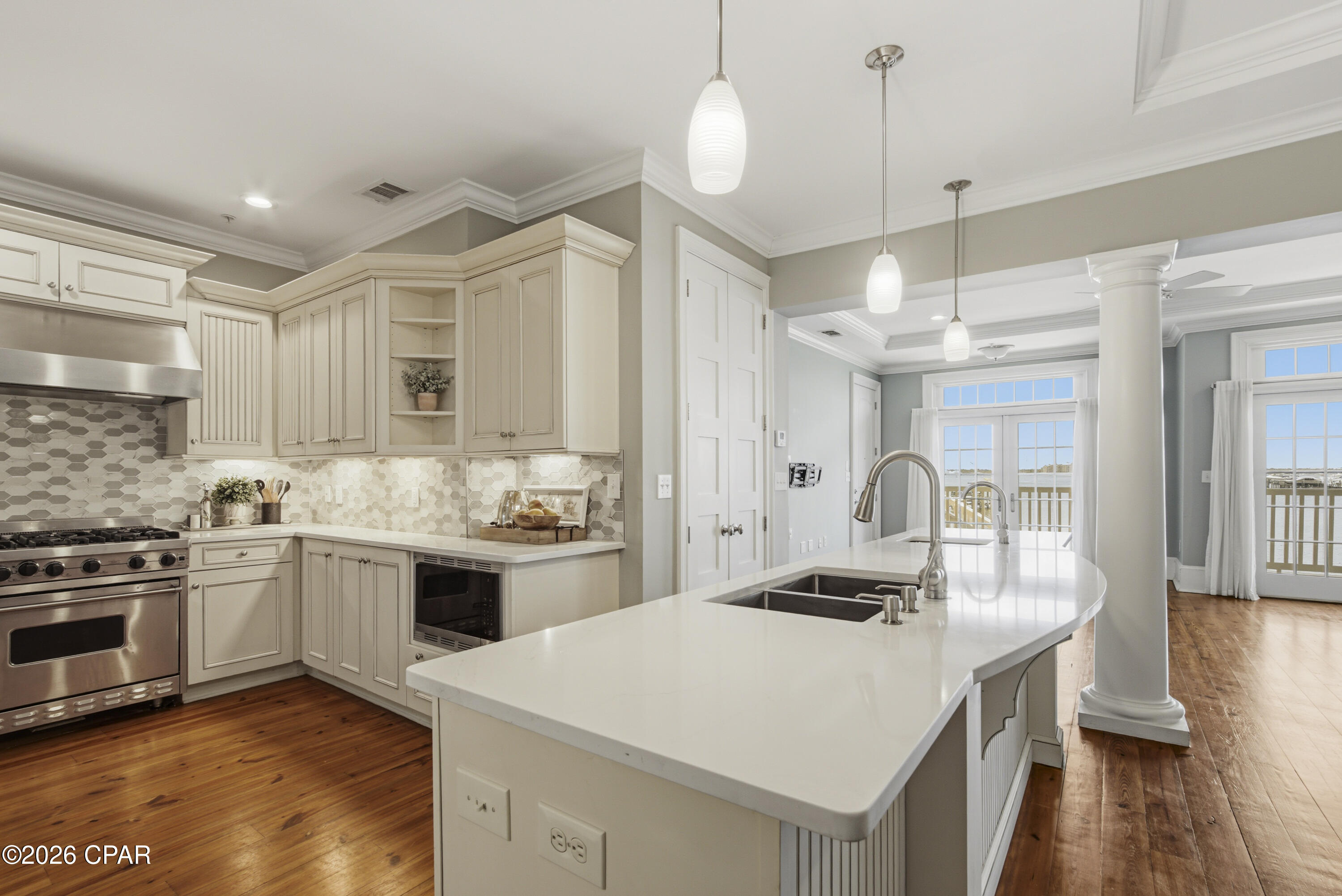 Welcome to Waterhaven, one of Panama City Beach's most sought-after gated waterfront communities on beautiful St. Andrews Bay. This exclusive non-rental community offers a peaceful coastal lifestyle with resort-style amenities, breathtaking bay views, and convenient access to beaches, boating, dining, and entertainment.

This spacious 3-bedroom, 2.5-bath waterfront residence offers approximately 1,608 square feet of thoughtfully designed living space with stunning bay views and an open-concept layout. While located on the first floor, the bay-side elevation provides the feel and vantage point of a second-floor unit, enhancing natural light and delivering elevated water views. Rich hardwood floors, tall ceilings and elegant molding details add warmth and timeless sophistication throughout. This exceptional condo combines privacy, luxury, and convenience.

The beautifully updated kitchen blends elegance and functionality, featuring a Viking gas range, Sub-Zero refrigerator, quartz countertops, designer tile backsplash, under-cabinet lighting, a Kraus faucet, deep undermount stainless steel sink, and recently updated dishwasher, microwave, and garbage disposal. The spacious living and dining areas flow seamlessly to a large covered balcony, the perfect place to enjoy breathtaking sunrises over St. Andrews Bay.

The primary suite offers tranquil water views through elegant French doors and features a beautifully updated spa-inspired bath with new countertops, vessel sinks, modern faucets, updated lighting, and a soaking tub designed for ultimate relaxation.

Two additional bedrooms provide space for guests, family, or a home office and share a convenient Jack-and-Jill bath. Both bedrooms feature private access to the community-side porches, creating an inviting extension of outdoor living and coastal atmosphere.

Residents enjoy exceptional resort-style amenities, including a bayfront pool, a beautifully appointed clubhouse with a fitness center, theater, and meeting room, as well as one of the largest private piers in Bay County. It the perfect spot for fishing, boating, and taking in the breathtaking views of St. Andrews Bay.

Conveniently located near marinas, beaches, dining, shopping, golf courses and St. Andrews State Park, this remarkable waterfront residence offers the coastal lifestyle you've been dreaming of.