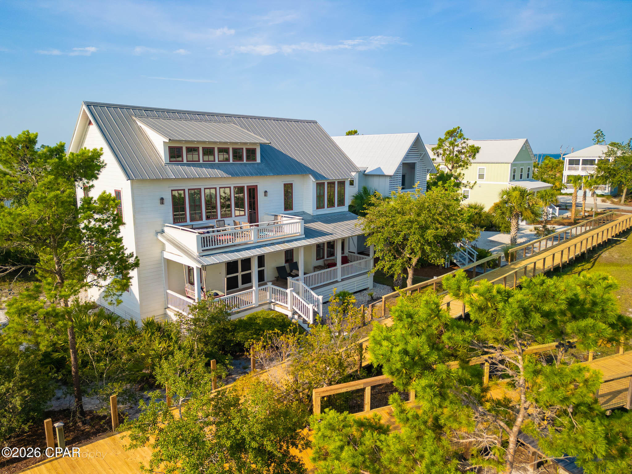 One of a kind in Windmark Beach, this custom built residence stands apart in a community built on architectural character, offering design and craftsmanship you will not find duplicated.
The main house offers three bedrooms and three bathrooms. A detached two car garage with a carriage house above adds a private one bedroom, one bath retreat, ideal for guests, rental income, or a quiet space of one's own.
Set near the Village Center of Windmark, the home connects directly to one of Windmark's newly rebuilt boardwalks, a short walk to the beach. The lagoon pool and downtown Windmark are within easy reach, all inside a walkable and golf cart friendly waterfront community.
Expansive outdoor living spaces extend the home's footprint into the coastal setting.
Offered fully furnished. 105 Washboard Court is a rare original in a neighborhood of good design. Opportunities like this do not come twice!