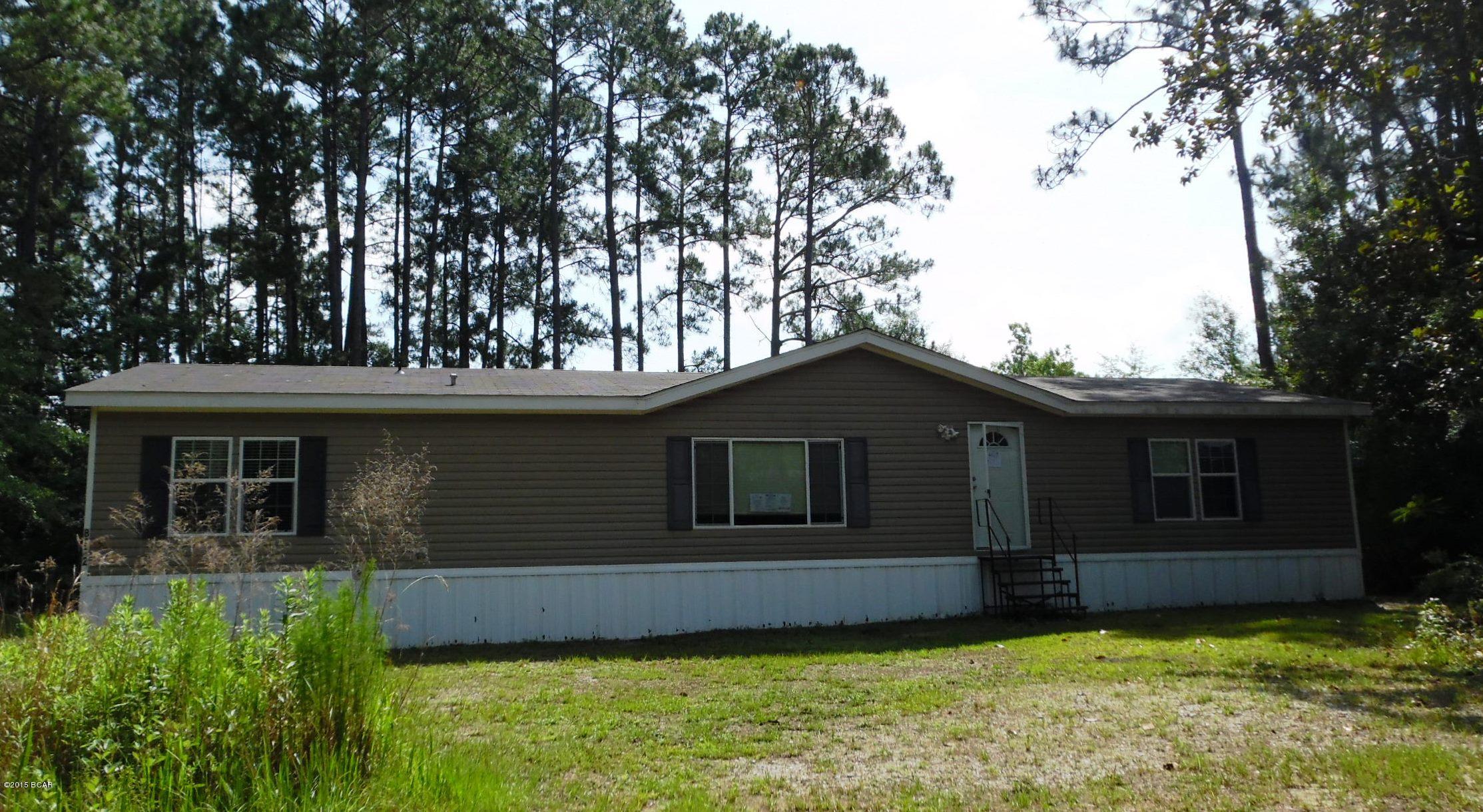 Don't miss out on a great opportunity to own this Like New 2009 model.   It's a  lovely 3 Bedroom, split floorplan home, with a HUGE master bed/bath ensuite, complete with walkin closet.  The living/dining/kitchen and bath flooring is low maintenance, tile-look vinyl and the carpet in bedrooms is in very good condition.  The kitchen is large, with a lovely center island/bar and there is crown molding on the cabinets and in every room at ceiling.   This home sits on almost an acre of land.  Don't wait to make your appointment to see this beauty.  (All info/dimensions/sizes are approximate and buyer to verify any info that is important.)
