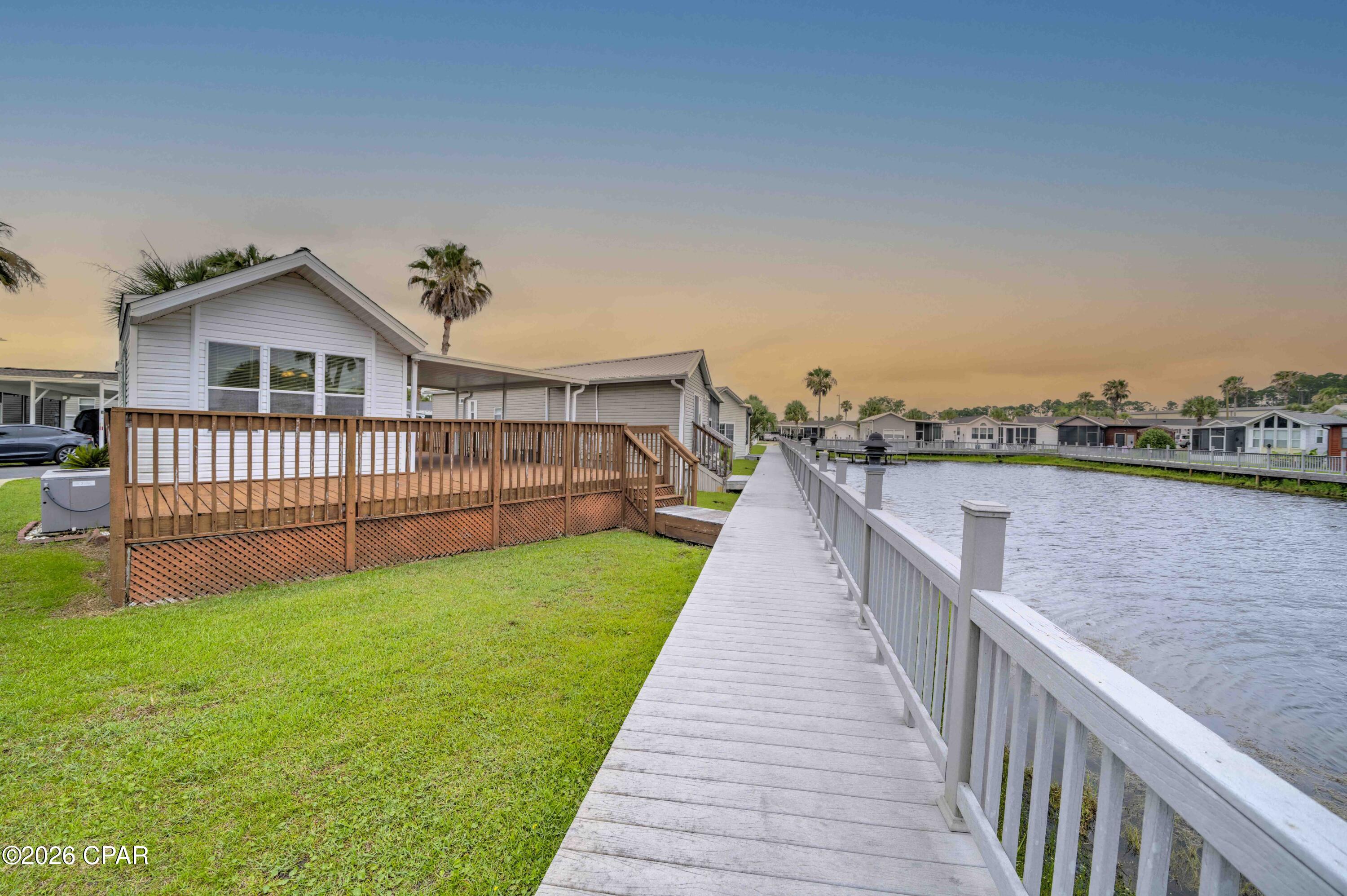 Welcome home to one of the most affordably priced waterfront properties in Emerald Pointe Resort, one of Panama City Beach's most desirable communities. This 1-bedroom, 1-bath home features a spacious loft that can serve as an extra sleeping area or game room, plus a living room with a divider that creates additional space for sleeping or relaxing while enjoying the lake view. The home also offers an open kitchen, a covered side patio, and a large deck overlooking the community lake. With its versatile layout, this property is well suited as a primary residence, vacation home, or investment opportunity. Recent updates include luxury vinyl plank flooring throughout, and an HVAC system installed in 2017.
Emerald Pointe Resort is a golf cart-friendly community in the heart of Panama City Beach, just minutes from restaurants, shopping, and the area's famous beaches. Community amenities include a large clubhouse, fitness room, two pools (one seasonally heated), a hot tub, a lake with a boardwalk, and a shuffleboard court. The HOA fee covers water, sewer, trash, WIFI, and lawn service. Schedule your appointment today to see all this home and community have to offer. All information is approximate and should be verified by the buyer if important.