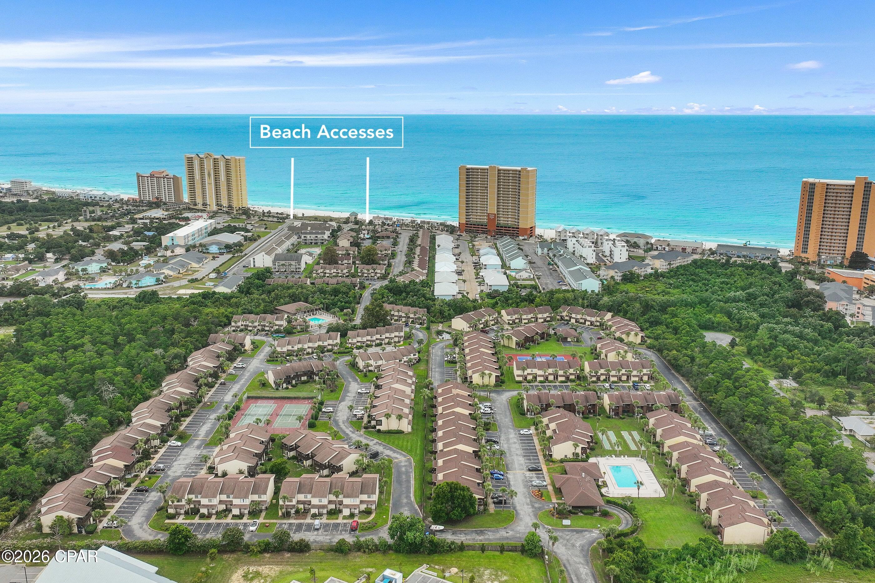 Get ready to fall in love with this beautifully designed condominium just a short distance from the beach! This gem features two spacious bedrooms and two full baths, along with three charming covered porches that invite you to enjoy a laid-back coastal lifestyle. Being an end unit, there are no neighbors above or below, and the offset placement gives each unit plenty of privacy when relaxing outdoors. You'll be wowed by the delightful coastal decor and the neutral LVP flooring that flows seamlessly through the living area and throughout the second floor. The living room is an ideal haven for relaxing, catching up with friends, or enjoying your favorite shows. On the first floor, you'll find a welcoming dining area, a full bathroom, and a bright and airy kitchen.

This kitchen is equipped with a refrigerator, a coveted gas range, an under-mount sink, and a convenient garbage disposal, all surrounded by granite countertops. Plus, the two exterior closets are perfect for storing all your outdoor furniture and beach toys!

When it comes to relaxation, the second-floor primary bathroom does not disappoint, boasting a linen cabinet, a sleek glass shower enclosure, and stylish laminate flooring.

As part of the Beachwalk community, you'll enjoy fantastic amenities such as a sparkling swimming pool, pickleball and tennis courts, a community room, and a dedicated pet walking area, making it easy to embrace the vibrant beach lifestyle. Located just minutes away from local favorites like Salty Sue's and Mike's Oyster Bar, this stunning condo is also just 3.4 miles from the attractions of Pier Park.

With a private bridge that leads to beach access 72 (via Wendwood Condos), you can easily take a leisurely nine-minute walk to the sand and surf. Don't miss out on this extraordinary opportunity to own a slice of paradise!