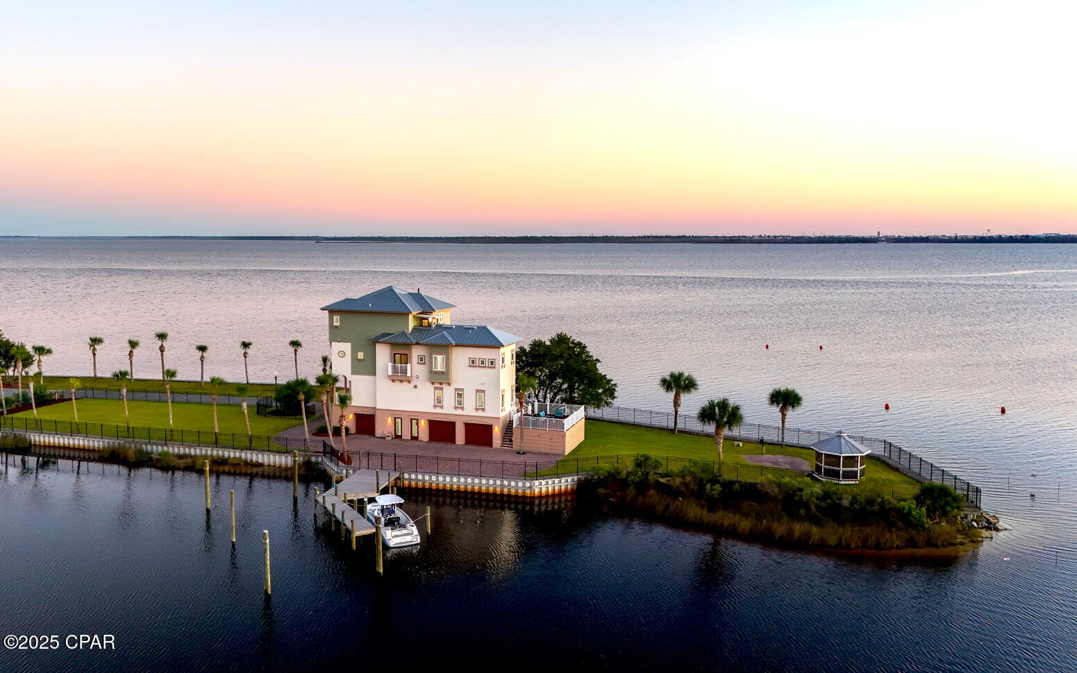 Welcome to 34 Palms A One-of-a-kind Waterfront Oasis Redefining Luxury Coastal Living. Experience the pinnacle of Florida waterfront living at 6701 Yacht Club Drive, a remarkable 0.83-acre peninsula estate with 360 panoramic bay views and endless adventure come together. Perfectly positioned with water on all sides, this 4-bedroom, 5-bath, 4,125-square-foot home captures the essence of the Florida boating lifestyle where every sunrise, sunset, and gentle breeze reminds you that you've arrived somewhere truly special. A Boater's Paradise: With direct Gulf access from your backyard, 34 Palms is your personal gateway to the open water. Offering both a private dock and an additional community boat slip, this property was designed for those who love to live life on the water. The calm bay setting is also perfect for kayaking, paddle-boarding, and jet skiing, all from the comfort of your home.
Outdoor Living at Its Finest: Every inch of the estate was designed to celebrate outdoor living. Expansive decks and palm-lined walkways lead to multiple lounging areas ideal for entertaining or simply soaking in the serenity. Surrounded by lush tropical landscaping, this private oasis allows you to fish, paddle, or relax in complete tranquility  all while enjoying breathtaking views unique to its peninsula setting.

Elegant Interiors & Inspired Design: Inside, natural light pours through floor-to-ceiling windows, illuminating open living spaces that seamlessly blend indoor and outdoor living. The heart of the home a bright, modern kitchen and inviting living area is perfect for both gatherings and quiet reflection, offering stunning water views from every angle.

Luxurious Private Retreats: The primary master suite, perched on the top floor, provides a peaceful sanctuary with a private balcony, outdoor shower, and sweeping sunrise-to-sunset views. A third-floor guest suite offers its own ensuite bath and walk-in closet, while two additional bedrooms share a charming Jack-and-Jill bath ideal for family or guests. A three-car garage with an office or workshop space completes the thoughtful layout.

Key Features Include: 

-0.83-acre peninsula lot with water on all sides.
-Over 500+ of Waterfront.
-Private dock plus community marina boat slip
-Direct Gulf of Mexico access for boating and fishing.
-Expansive 4,125 sq. ft. of light-filled living space.
-Multiple decks and outdoor entertaining areas
-Lush tropical landscaping.
-Waterfront Gazebo with Private Beach. 
-Largest lot in East Bay PreserveMore than a home. 

34 Palms is a lifestyle one defined by endless horizons, outdoor adventure, and effortless elegance. Discover unparalleled waterfront living where every day feels like a getaway.

Schedule your private tour today and experience how 34 Palms redefines luxury coastal living.