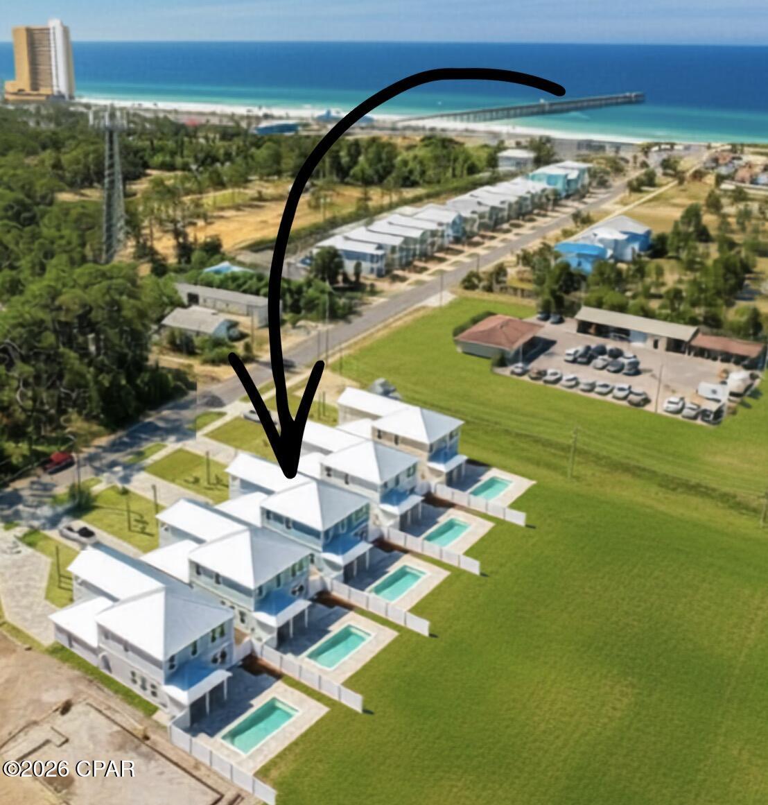Coming Soon - No Showings. Beach Within Reach! Short-Term Rental Pool Home Priced to Sell! Just a short stroll to the sugar-white sands of Panama City Beach, the MB Miller County Pier, restaurants, and attractions, this beautifully furnished new construction coastal retreat offers the perfect combination of luxury, location, and income potential. With rental projections approaching $200,000 annually, this six-bedroom, four-bath home is an exceptional opportunity for investors or those searching for the ultimate beach getaway.

The backyard is your own private resort, featuring a 24' x 10' gunite pool surrounded by elegant pavers, a fully fenced yard, and an outdoor shower--perfect for rinsing off after a day at the beach. There's plenty of room for lounge chairs, entertaining, grilling, and enjoying Florida's sunshine.

Inside, the coastal modern design is both stylish and inviting. The open-concept living area is designed for gathering, complete with a spacious family room, oversized flat-screen TV, and a chef-inspired kitchen featuring quartz countertops, stainless steel appliances, a large breakfast bar, and a generous dining area. Everything is move-in ready, including the washer and dryer.

The thoughtfully designed floor plan offers a spacious primary suite on the main level overlooking the pool, along with a second guest bedroom and full bath. Upstairs, you'll find another luxurious king suite with a private ensuite bath, a queen bedroom with its own balcony, an oversized custom bunk room that comfortably sleeps six, and a sixth bedroom currently configured as a media/playroom with a sleeper sofa and large-screen TV, providing flexible space for additional guests.

Additional features include a garage for storing beach gear and bikes, ample parking, quality coastal furnishings throughout, and the home is being sold fully furnished, making it truly turnkey for immediate enjoyment or rental income.

Whether you're looking for a high-performing vacation rental, second home, or full-time coastal residence, this exceptional property delivers the beach lifestyle buyers are searching for. Beach within reach, luxury at your doorstep, and income potential that's hard to beat!