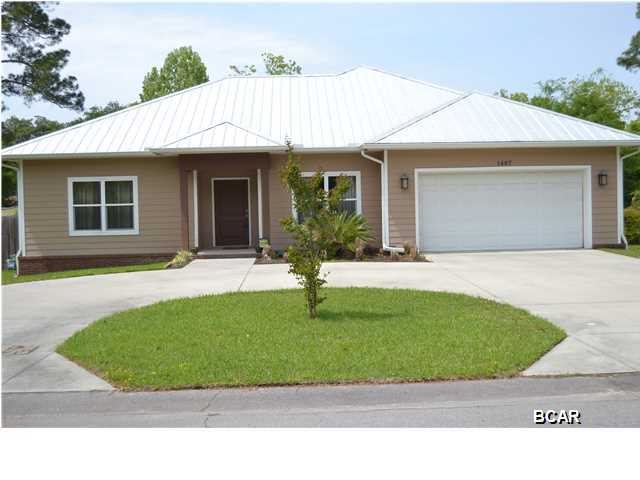 Energy efficient, sturdy insulated concrete constructed 3 bedroom, 2 bath home located in St Andrews, close to shops, restaurants, hospitals and St Andrews Bay. This home was custom built by the owner with efficiency and low maintenance in mind. The exterior of the home is hardi board siding with a metal roof low E impact glass and the walls are solid concrete styrofoam formed for durability. The interior of the home has decorative stained concrete floors, granite counter top and vanity tops and tall ceilings. The kitchen has large ''pots and pans'' drawers, solid wood cabinets, breakfast bar, and built cabinets in the breakfast nook PLUS a generous appliance package. A formal dining room is just off of the kitchen. The living room is bright and airy and open to the eat in kitchen.  The master bedroom is 16x16 (HUGE) and features a master bath with a double vanity, walk in closet and tub/shower combination. Two remaining bedrooms are 13x12 and share a full bath. A covered back patio overlooks the well manicured fenced in back yard. For storage the home has a two car attached garage and a metal shed in the back yard. If you have been looking for a sturdy, like new, energy efficient home in St Andrews, this is the one!!!! Call today!