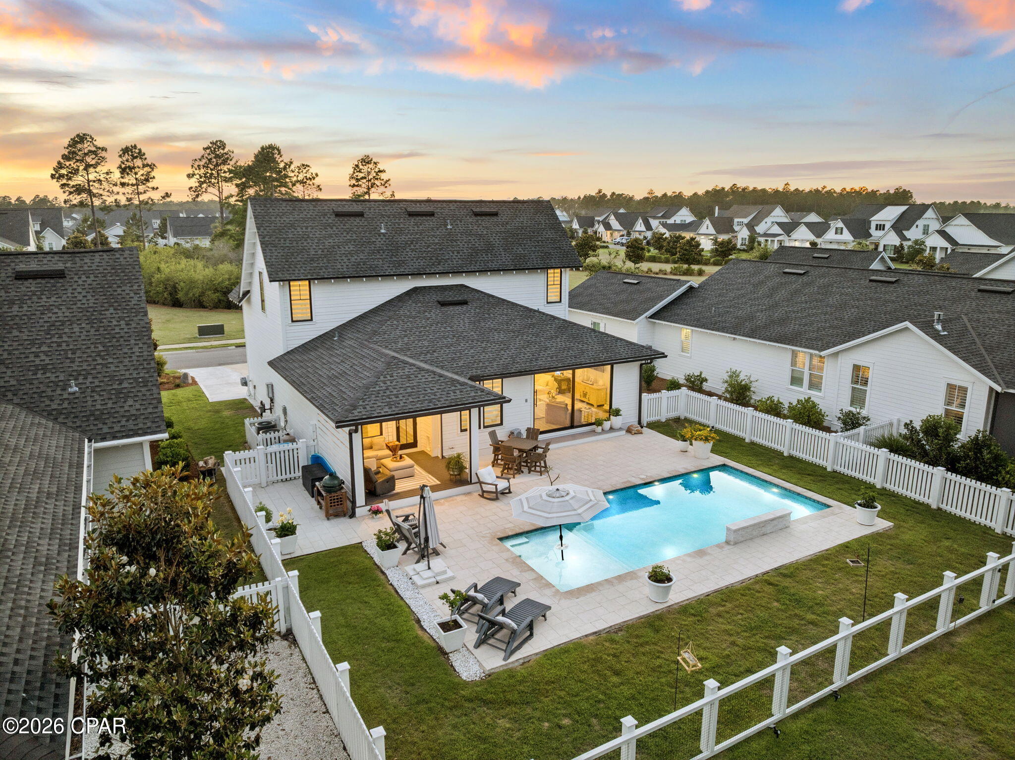 Set on a deep 133-foot lot with a private wooded preserve behind the home and a community green space directly across the street, this 2020 Huff Home offers something increasingly hard to find in Watersound Origins: no rear neighbors, and an open outlook in front instead of another roofline staring back at you. 

This Draper II plan opens through a wide sliding door in the main living area that frames the pool and preserve beyond. Outside, a 14x27 pool with a sun shelf anchors an expansive paver patio, set behind a privacy fence with mature pines rising past the back line. A screened porch with motorized screens - accessed off the kitchen - extends the living space and makes daily outdoor use practical year-round. 

One of the highlights of the home is the kitchen - open, light, and positioned to take advantage of the pool view through the rear sliders. Quartz island, Bosch stainless, gas range, and wood
cabinetry give it the kind of finish you'd expect at this price point without feeling overdone. Luxury vinyl flooring runs throughout, and the closets are built out across the bedrooms. The floor plan puts the primary suite on the main level, with three more bedrooms and a second living space upstairs - a layout that works equally well for full-time families and for hosting guests. At 2,220 square feet, the home includes 4 bedrooms, 3.5 baths, and a 2-car garage. Exterior
details reflect the same attention throughout: heirloom brick, bronze windows, and rain gutters.

Watersound Origins offers an unparalleled coastal lifestyle with access to a state-of-the-art fitness center, seasonally heated community pool, Lake Powell dock access with community kayaks and canoes, an executive golf course, tennis & pickleball courts, and miles of scenic trails. For the ultimate beach experience, owners can join the St. Joe Beach Club, unlocking private beach access, multiple pools, Gulf-front dining, and exclusive golf courses (Camp Creek, Watersound III & Shark's Tooth).

Ideally located just minutes from the new Publix town center, Scenic Highway 30A's top restaurants, boutiques, and year-round events, this one-of-a-kind property offers a rare opportunity for resort-style living in a prime location.