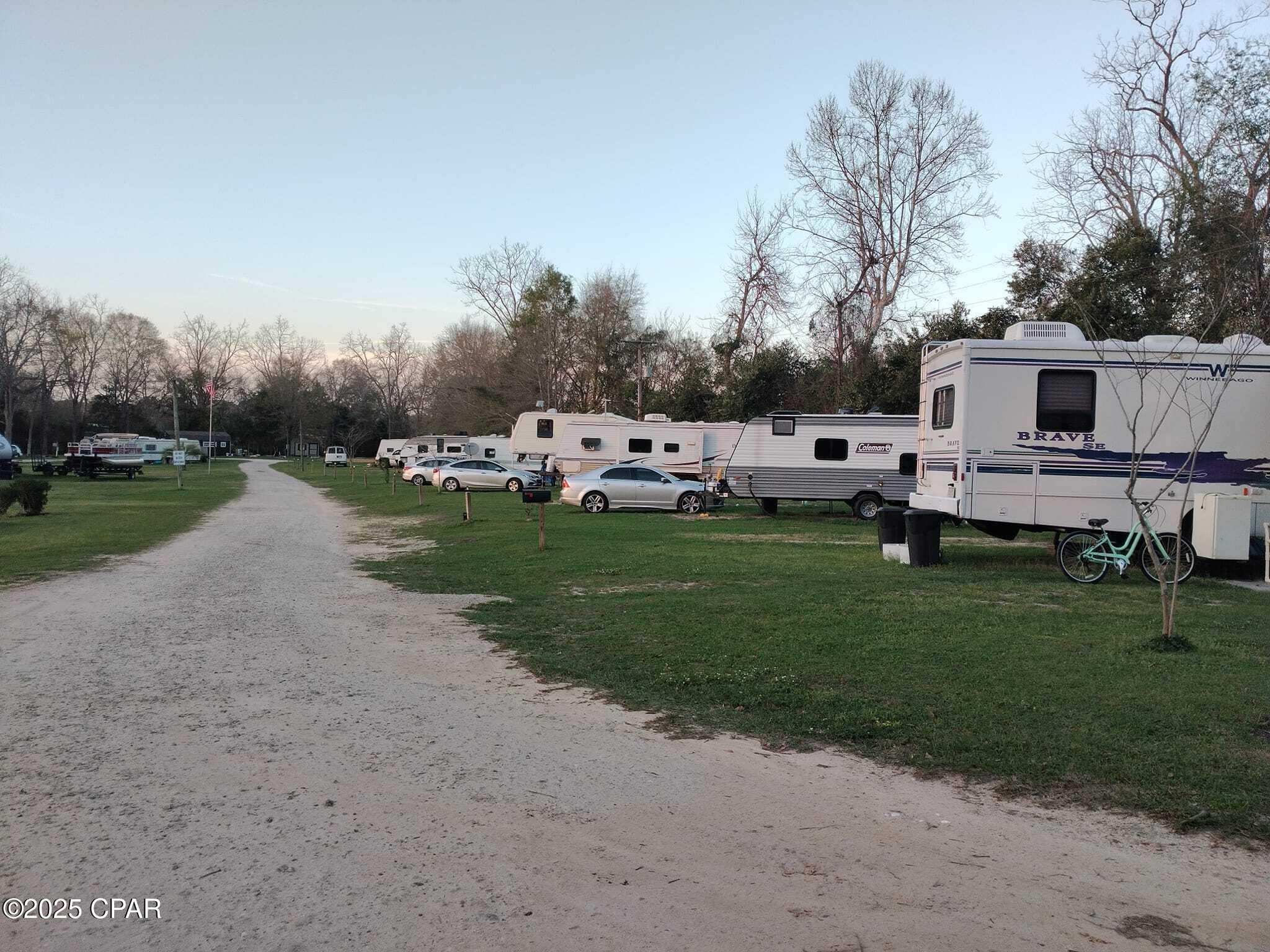 Discover this well-maintained, income-producing RV park situated on just under 6 acres of beautifully treed land featuring mature pecan, sycamore, and oak trees. The property offers 23 RV sites, each with separate electric meters, plus a rented tiny home generating approximately $1,000/month, and an 1,100 sq. ft. on-site manager's home. Currently, 11 long-term tenants are on month-to-month agreements, providing stable, flexible income. Infrastructure includes a crushed concrete drive built to support large RVs, a loop water system, four septic tanks, and underground utilities in conduit. Tenants enjoy a spring-fed pond, three picnic areas, coin-operated laundry, fiber optic internet, and security cameras with lighting throughout the property. This park is thoughtfully designed for low-maintenance management and long-term growth--an excellent opportunity for investors seeking a strong cash-flowing asset with expansion potential. 💼 Investors - Bring All Offers! Don't miss this rare chance to own a thriving, turnkey RV park with proven income and room to grow.