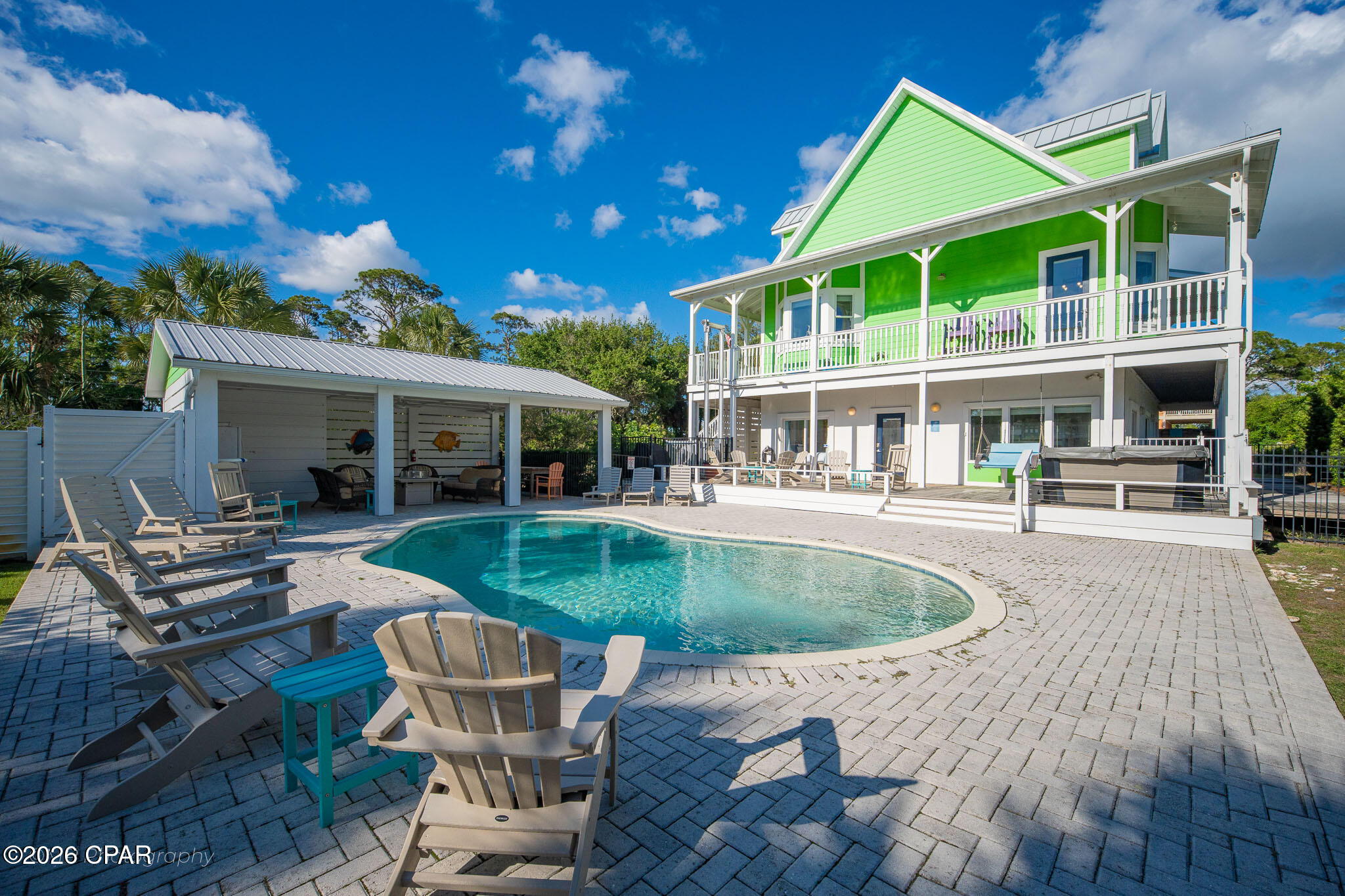 Discover the Forgotten Coast at its finest in the highly sought-after Two Palms, a Gulf front community on Cape San Blas. This stunning 6-bedroom, 4-bath retreat offers 3,245 square feet of elevated coastal living, built for unforgettable gatherings and effortless relaxation. The resort-style outdoor oasis steals the show with a private pool, soothing hot tub, covered pavilion with gas grill, gas fire pit, and hot/cold outdoor shower, creating an entertainer's dream beneath the swaying palms. Three levels of thoughtfully designed living space accommodate 15+ guests. The second-floor great room is the heart of the home, with open concept living, dining, and kitchen areas bathed in natural light. A king primary suite with en suite Jacuzzi tub and private deck access serves as a true owner's retreat, while two additional king suites upstairs and queen and bunk rooms below offer flexibility for multi-generational getaways. A media room, lift elevator, EV charging, and parking for five round out the home. The location is unbeatable. Two private community beach boardwalks sit just a short walk away, delivering you to sugar-white sands and emerald Gulf waters. Directly across the street, Salinas Park offers immediate access to St. Joseph Bay, a kayaker's and angler's paradise, along with the Serenity Trail for sunset bike rides and scenic walks along the bay. Stroll to Scallop Republic for bayfront music and cocktails. Beyond your doorstep, T.H. Stone Memorial St. Joseph Peninsula State Park sits five miles away with pristine shoreline and hiking trails. Historic Port St. Joe offers boutique shopping and waterfront dining, while Indian Pass, Apalachicola, and Mexico Beach serve up the freshest Gulf-to-table seafood in the South. Whether you seek a turnkey luxury second home, a proven income producer, or a forever coastal compound, this rare gem delivers. The Gulf is calling you now.