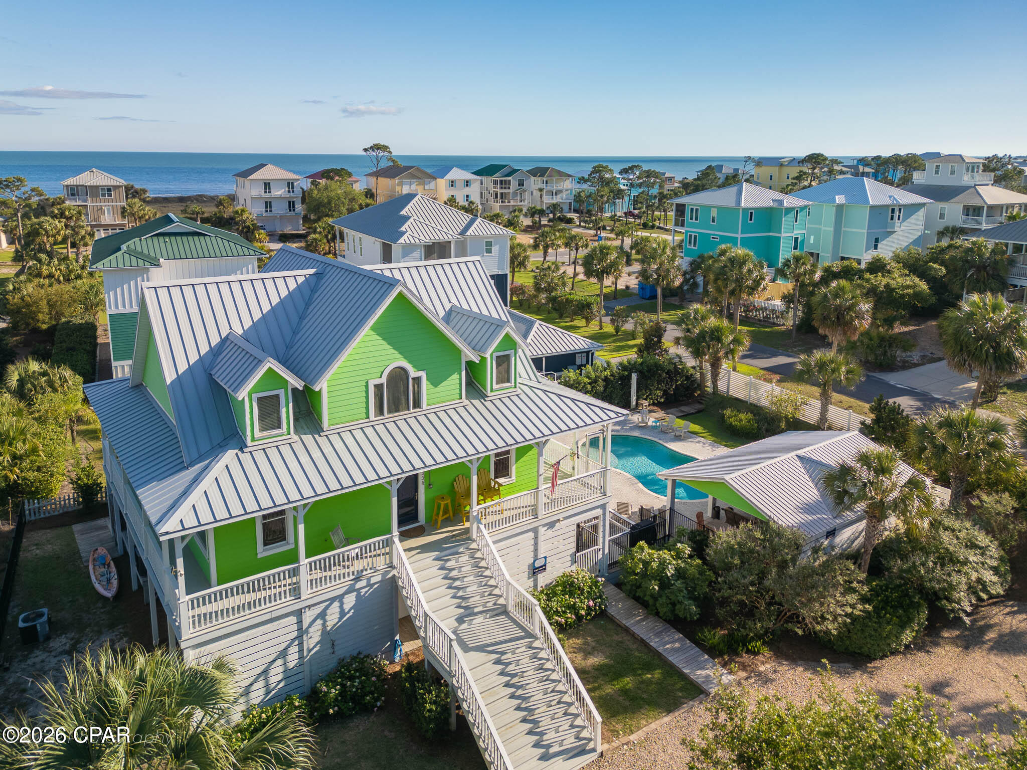 Discover the Forgotten Coast at its finest in the highly sought-after Two Palms, a Gulf front community on Cape San Blas. This stunning 6-bedroom, 4-bath retreat offers 3,245 square feet of elevated coastal living, built for unforgettable gatherings and effortless relaxation. The resort-style outdoor oasis steals the show with a private pool, soothing hot tub, covered pavilion with gas grill, gas fire pit, and hot/cold outdoor shower, creating an entertainer's dream beneath the swaying palms. Three levels of thoughtfully designed living space accommodate 15+ guests. The second-floor great room is the heart of the home, with open concept living, dining, and kitchen areas bathed in natural light. A king primary suite with en suite Jacuzzi tub and private deck access serves as a true owner's retreat, while two additional king suites upstairs and queen and bunk rooms below offer flexibility for multi-generational getaways. A media room, lift elevator, EV charging, and parking for five round out the home. The location is unbeatable. Two private community beach boardwalks sit just a short walk away, delivering you to sugar-white sands and emerald Gulf waters. Directly across the street, Salinas Park offers immediate access to St. Joseph Bay, a kayaker's and angler's paradise, along with the Serenity Trail for sunset bike rides and scenic walks along the bay. Stroll to Scallop Republic for bayfront music and cocktails. Beyond your doorstep, T.H. Stone Memorial St. Joseph Peninsula State Park sits five miles away with pristine shoreline and hiking trails. Historic Port St. Joe offers boutique shopping and waterfront dining, while Indian Pass, Apalachicola, and Mexico Beach serve up the freshest Gulf-to-table seafood in the South. Whether you seek a turnkey luxury second home, a proven income producer, or a forever coastal compound, this rare gem delivers. The Gulf is calling you now.