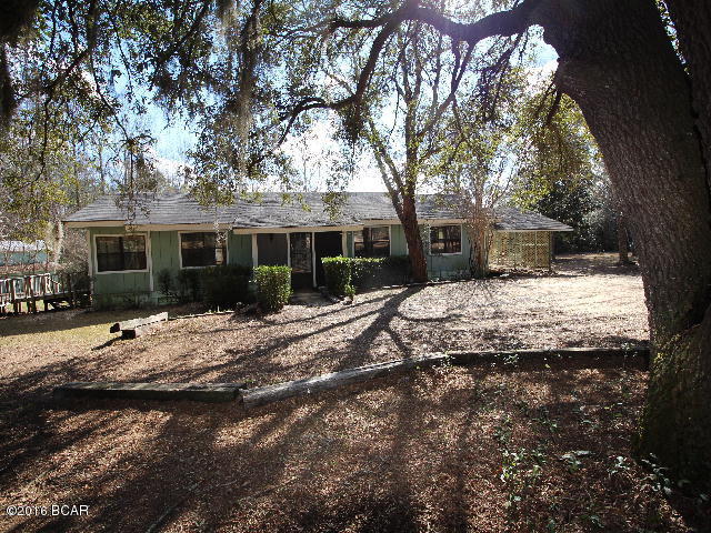 PRICE REDUCED!! Home located on large corner lot in Compass Lake in the Hills where you have so many nice amenities with ownership here. You have access to two lakes, fishing, boating, horseback riding, tennis, golf driving range, RV parking facilities, clubhouse facilities and much more! There is a nice restaurant located in the clubhouse for fine dining. The house is a large wood frame house with 2 large bedrooms, 2 baths, a sitting room beside the master bedroom, a large den with fireplace, a sunroom and a small office. There is a large barn/yard building that can be used for so many things. The house needs some updating and repairs but possibilities are endless here!