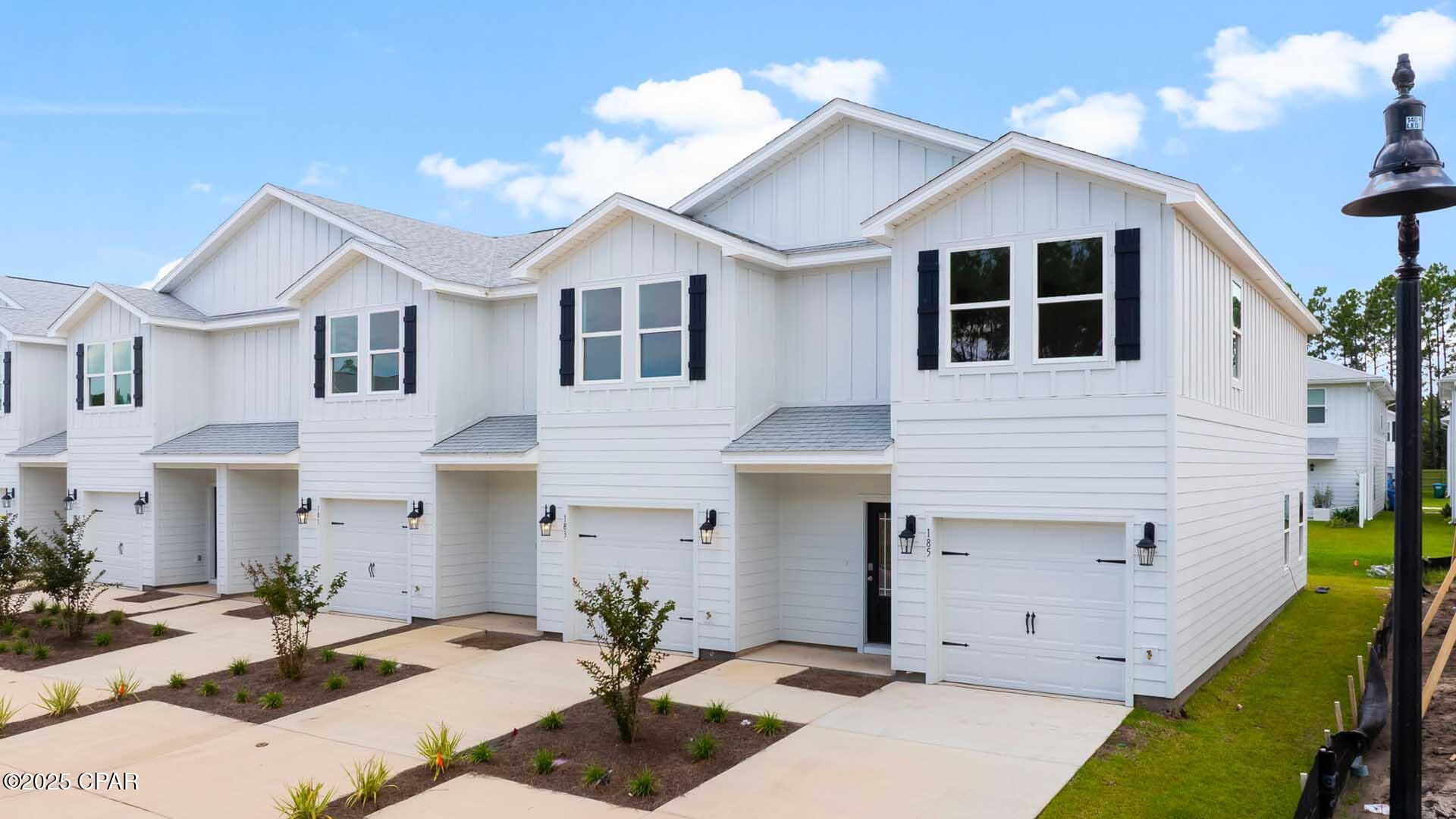 Welcome to 198 Ellery Lane at Bayside at Ward Creek in Panama City Beach Florida. This townhome is corner homesite and under construction. This townhome offers a welcoming space that has 3 bedrooms, 2.5 bathrooms, and a convenient single car garage. The bright entry leads to an open kitchen, living, and dining area that is designed for comfort and everyday living. The kitchen serves as the culinary center with a spacious center island, beautiful white cabinetry, granite countertops, and a premium stainless steel appliance package including a smooth top stove, microwave and dishwasher. Beautiful windows surround the living area allowing for natural light. 

The first floor is the heart of the home, while the privacy of the second level has all bedrooms, ensuring a quiet retreat. The main suite features a generous closet, an oversized shower, dual sink vanity, and a linen storage area in the private bath. Two additional bedrooms share a hall bath with shower tub combo that create a comfortable space for family or guests.   

 The interior features include EVP flooring throughout the main level and second level bathrooms and plush carpet on the stairs, upstairs hallway and bedrooms, Smart Home Technology Package comes standard, featuring a Qolsys IQ touch panel for thermostat and lighting control, ensuring security and convenience. Exterior features of Bayside at Ward Creek townhomes are equally impressive, with Hardie® siding and thoughtful lighting at the garage, front entry, and back patio. A landscaped front entry adds curb appeal and welcomes you to your very own slice of Florida paradise awaits. the back patio looks over the tree line with no neighbors behind you creating a great space to sit and enjoy nature. The community includes a pool, and playground just minutes away from the beautiful beaches, shopping and all the Panama City beach has to offer.  Call today for a tour of this floor plan.