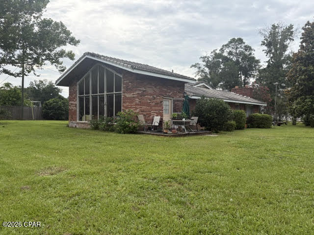 Looking for a property where you can tackle projects one day and go fishing the next? This brick ranch offers the perfect opportunity. Featuring access from two roads, residents-only boat ramps within walking distance, and plenty of room for gardening, the property already includes established blueberry bushes and fig trees.  A standout feature is the large two-story workshop with spray foam insulation, offering endless possibilities for hobbies, storage, or even conversion into an income-producing apartment. The Florida room features a wall of windows overlooking the spacious backyard, creating a peaceful space to relax and enjoy the view.  Conveniently located near the Chipola River, yet situated outside of a flood zone. This home needs some work, but for the right buyer, the potential and rewards will be well worth the effort.