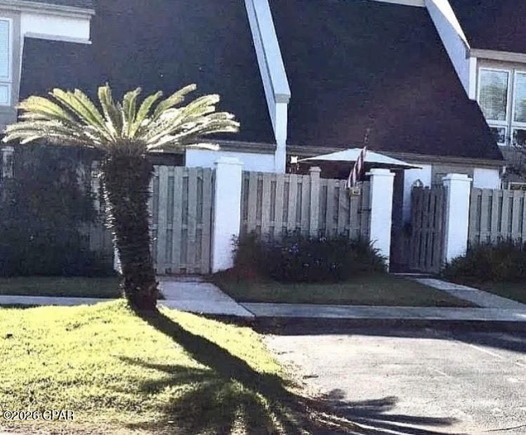 This townhouse boasts a a spacious layout and prime location within a gated community, just steps from the pro shop, Nicklaus Golf Course, Neon's bar 72, a popular neighborhood gathering spot. A brief walk leads to the marina and a 4-mile drive to Tootsie's and Schooners, local beachfront hotspots. This unit's location boasts beautiful sunsets and fireworks displays over nearby Grand Lagoon. Our sales price has been set to account for associated HOA Fees.