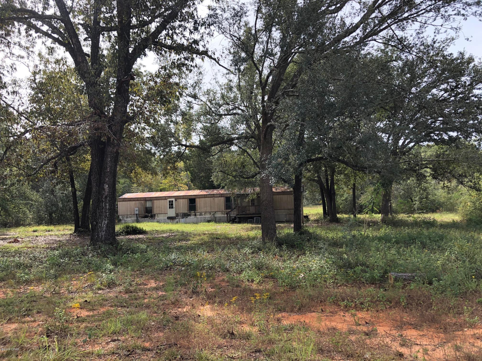 2.9 acres with well, septic, and power available on a level lot.  There is a 1983 mobile home  of no value that will need to be removed.  The owner is selling ''AS IS'', and will be buyer's responsibility  to remove the mobile home.

The Seller has not seen the property for few years and cannot warranty the condition of well and septic --will need to be inspected.

This is a nice lot for a home or mobile home package with beautiful trees and growth on it. Come take a look!