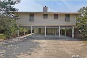 Listen to the Gulf waves from your private porch! Beautiful house in Blue Mountain Beach just one-half mile walk to the Gulf of Mexico. Open floor plan with living room, dining, and kitchen on the second floor, for nice views and breezes. Hardwood floors, tongue and groove pine walls, and 14 foot ceilings in the living room. Kitchen and dining area have granite counter tops, hardwood floors, a view of the backyard, and open to the wrap-around screen porch. Lots of windows let in the light and gulf breezes. And the wooded backyard and 6 ft privacy fence add plenty of privacy. The living area shares the 2nd floor with the master suite, 2 guest rooms, a guest bath, and laundry area. The private 4th guest room and 3rd bathroom are on the first level. Covered carport easily holds 4-6