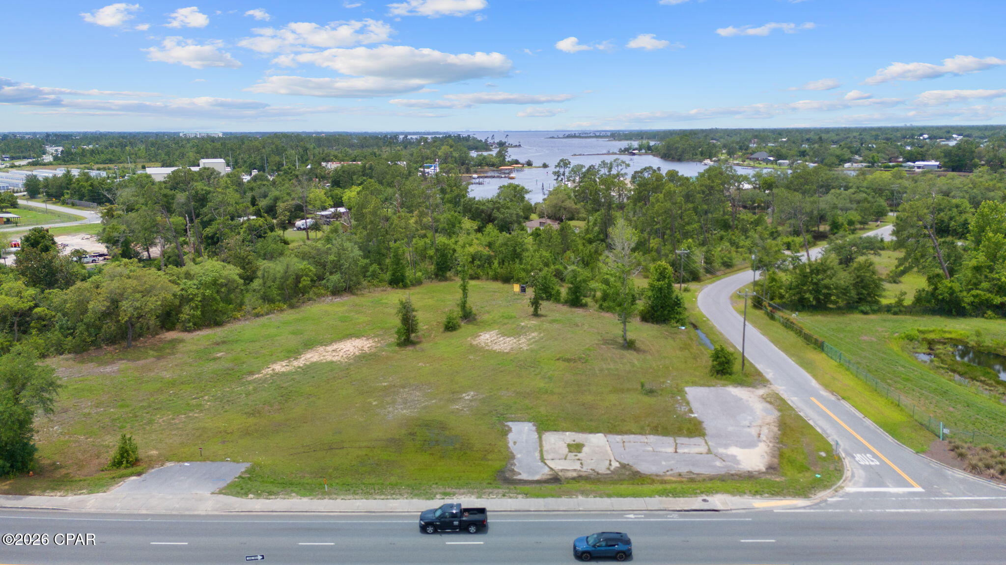 ±1.15-acre commercially zoned (C3) corner parcel located along the highly trafficked Highway 77 corridor in Southport. Positioned at the corner of Hwy 77 and Hwy 2321, the property offers direct ingress and egress, strong visibility, and exposure to approximately 29,000 vehicles per day.

This parcel serves as the primary access point for the adjacent interior lot at 7401 Hwy 77, creating an opportunity for expanded development when combined. Ideal for auto-oriented, retail, or quick-service commercial uses seeking high-traffic exposure.

Available individually or as part of a ±1.95-acre assemblage.
