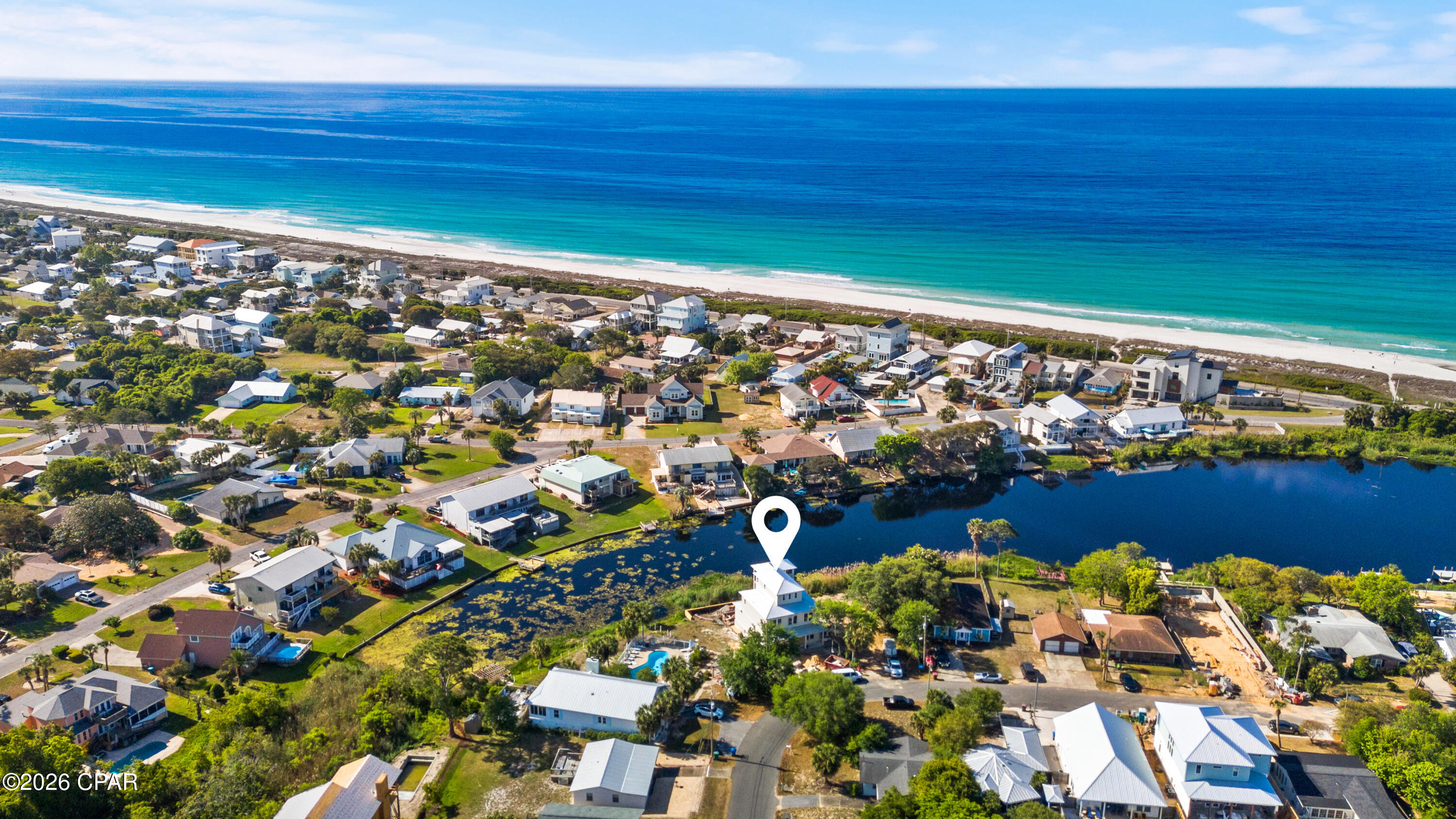 Coming Soon - No Showings. Now nearing completion at 340 Le Grand Drive, this exceptional new coastal residence offers a rare opportunity to secure a beautifully designed home just moments from the beach while still having the ability to personalize select finishes and fixtures. Thoughtfully planned as a 5-bedroom, 4-bath home, the three-story design blends refined architecture, curated designer selections, and effortless indoor-outdoor living in one of the area's most compelling settings.

Positioned with Riviera Lake just beyond the private pool and Gulf views from the upper levels, the home is designed to capture the beauty of its surroundings from multiple vantage points. The main living spaces are open and inviting, with a spacious kitchen, dining, and living area that flows seamlessly to covered outdoor living. Multiple porches and balconies create a layered coastal lifestyle, ideal for entertaining, unwinding after a day at the beach, or simply taking in the water views. The plans detail 2,815 square feet of living space and about 3,885 square feet under roof, along with a 24' x 12' pool, garage, and a flexible third floor with full bath that can function as the fifth bedroom, a game room, or a living space, all with gorgeous lake and gulf views.

Located approximately 1,000 feet from the beach, this home offers the convenience of beach lifestyle paired with the privacy and visual appeal of a lakefront setting. The anticipated completion date is roughly two months out, and a buyer who acts now has the unique advantage of stepping into a nearly finished new construction home while still participating in the selection of certain finishes and fixtures--an increasingly rare opportunity in today's market.

Sophisticated yet relaxed, polished yet personal, 340 Le Grand Drive is ideal for the buyer seeking a luxury coastal retreat with designer character, strong visual presence, and meaningful involvement in the final details.